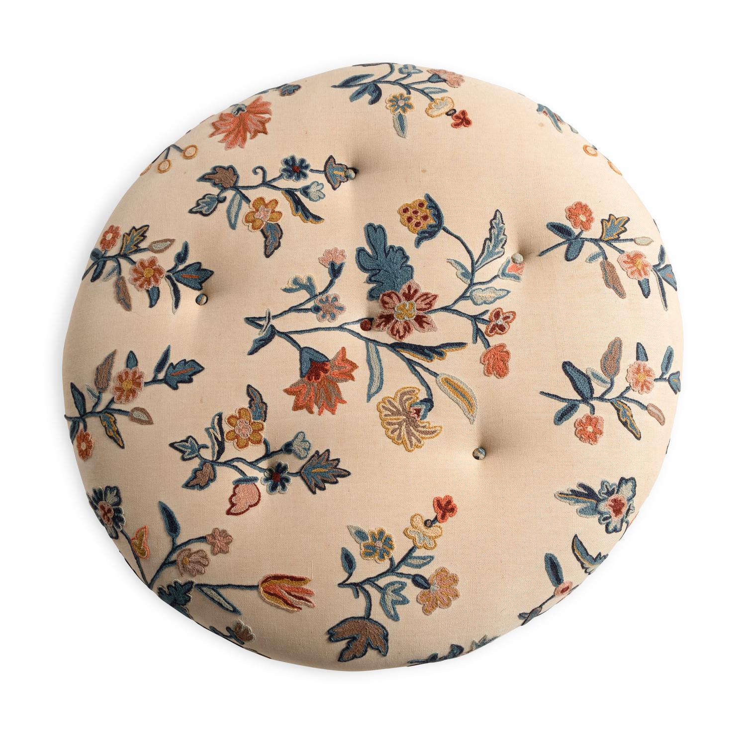 A Button-Tufted Circular Ottoman with Crewelwork Upholstery
