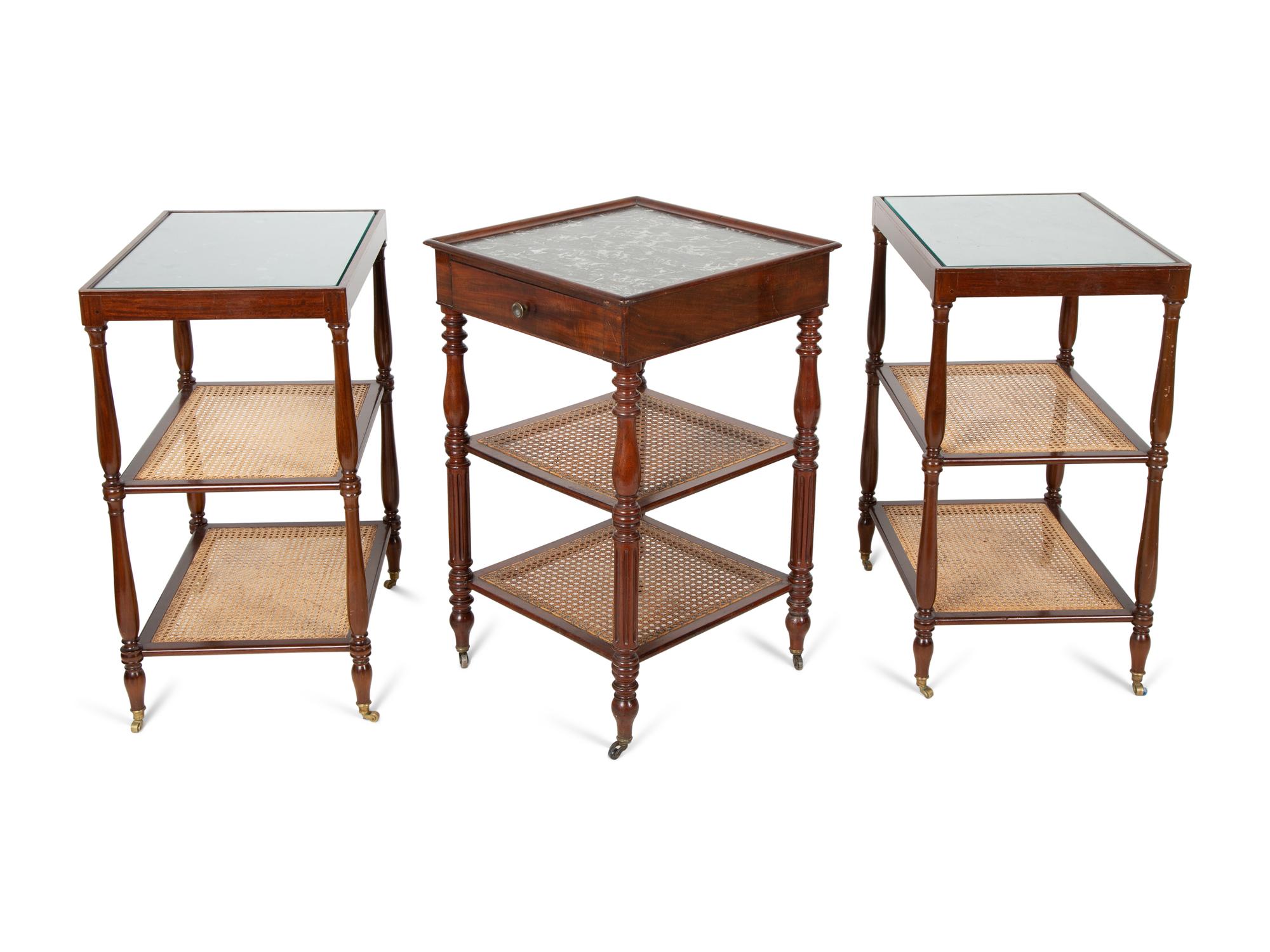 A Group of Three French Mahogany Marble Top Side Tables with Tiered Canework Shelves — EARLY 20TH CENTURY