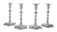 A Set of Four American Silver Candlesticks, Early 20th Century, cast from a Georgian Model, the shaped circular bases with shells at in