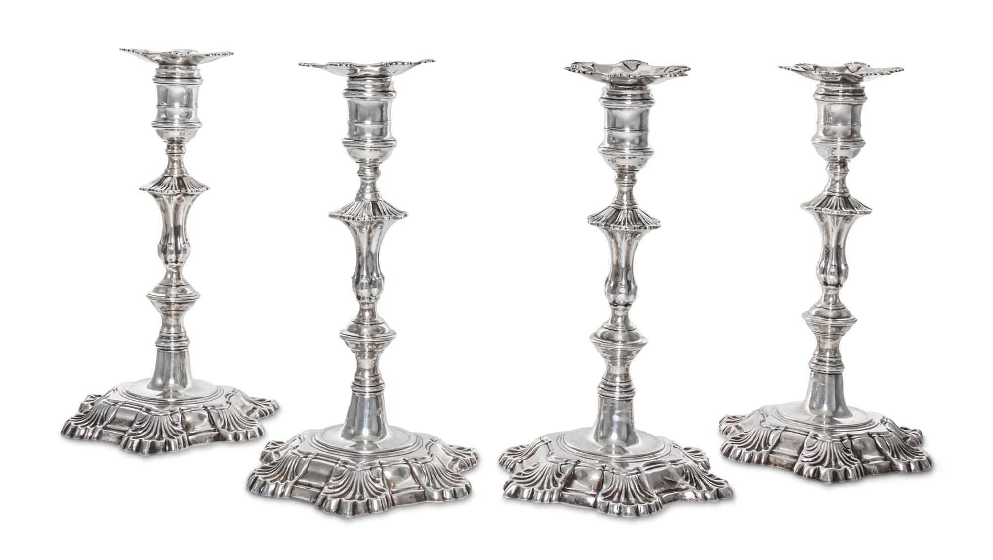 A Set of Four American Silver Candlesticks, Early 20th Century, cast from a Georgian Model, the shaped circular bases with shells at in