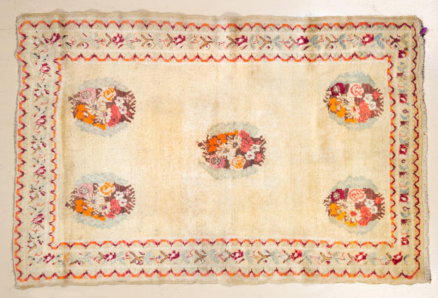 A Wool Area Rug 4 feet 8 3/4 inches x 4 feet 4 1/2 inches.