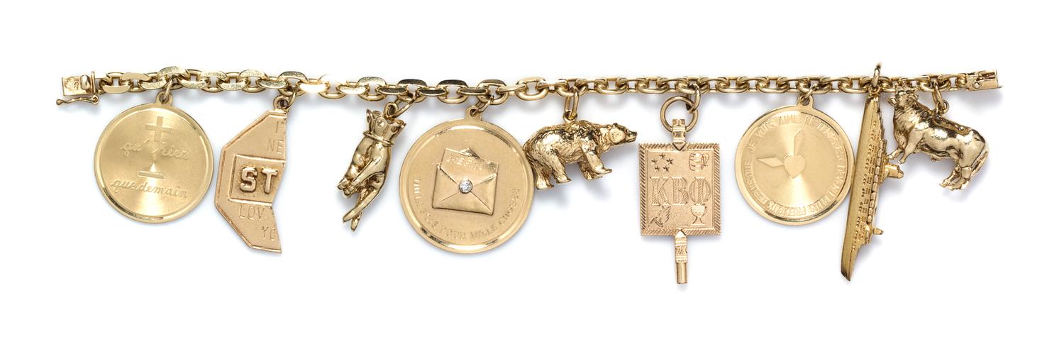 A 14 Karat Yellow Gold Charm Bracelet with Nine Attached Charms, 55.10 dwts.