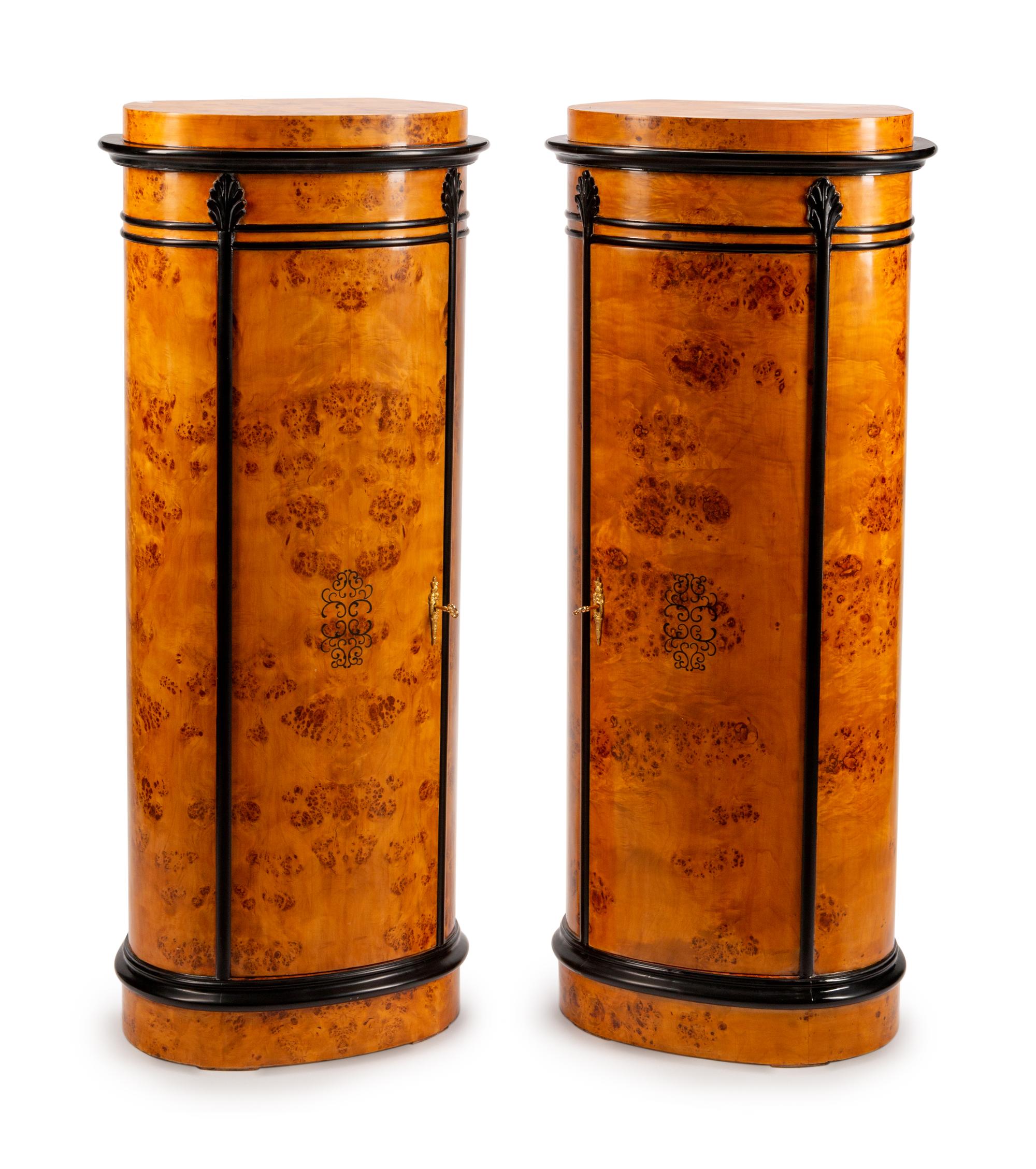A Pair of Danish Oval Pedestal Cabinets