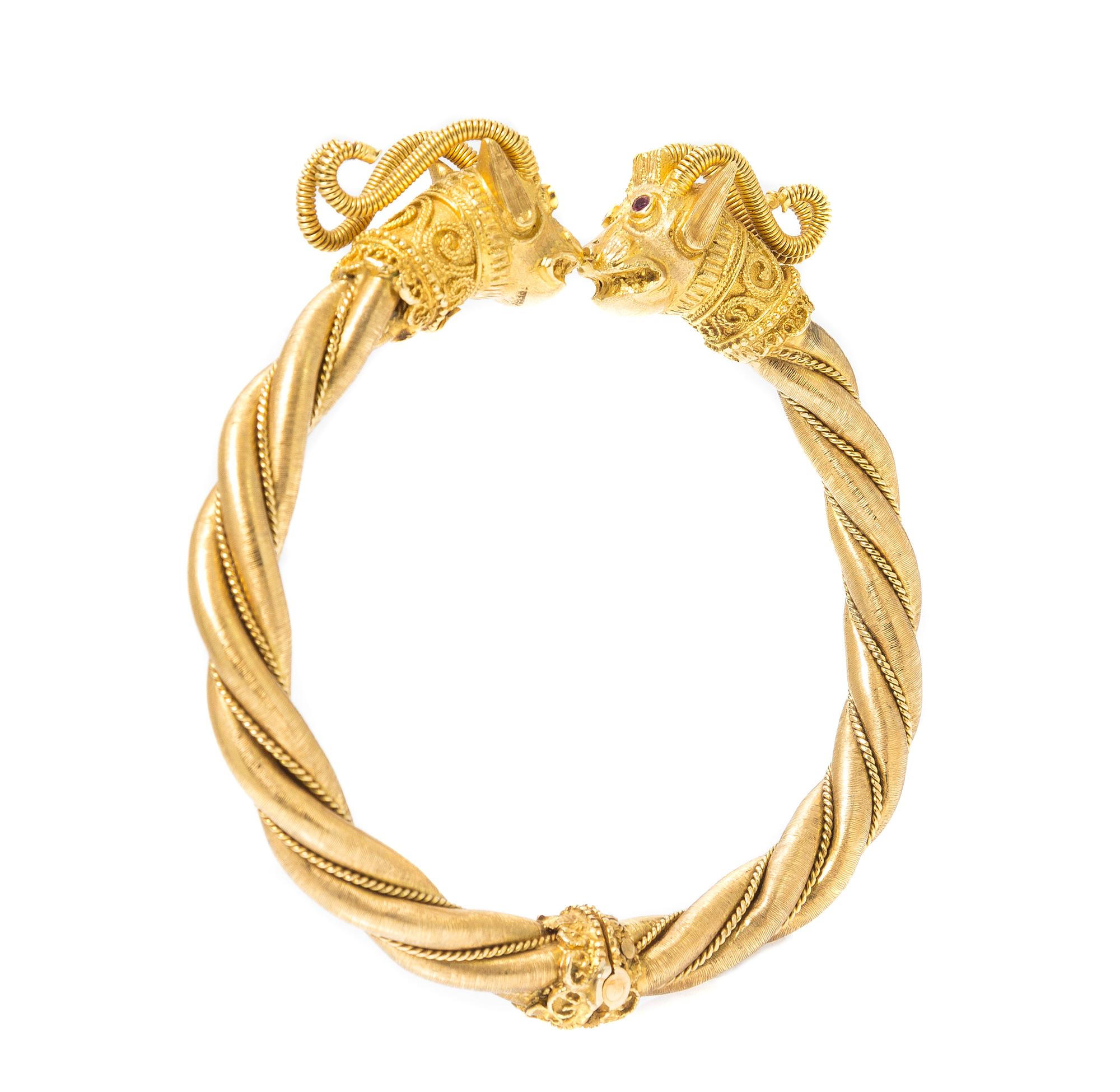 An 18 Karat Yellow Gold and Ruby Rams Head Bangle Bracelet, 34.80 dwts.