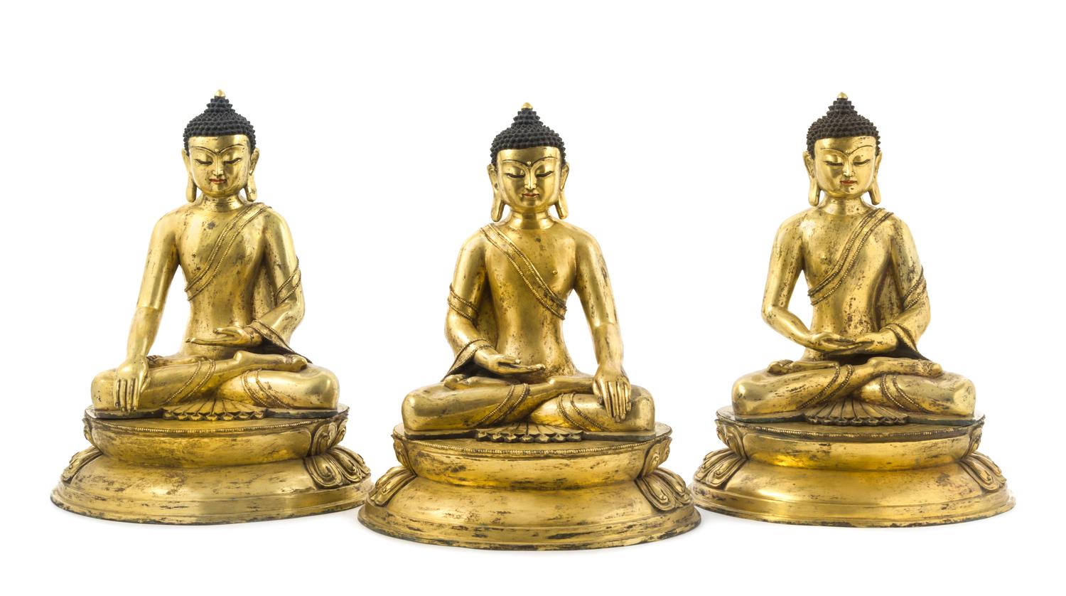 A Set of Three Gilt Bronze Figures of Buddha Height of set 17 inches.