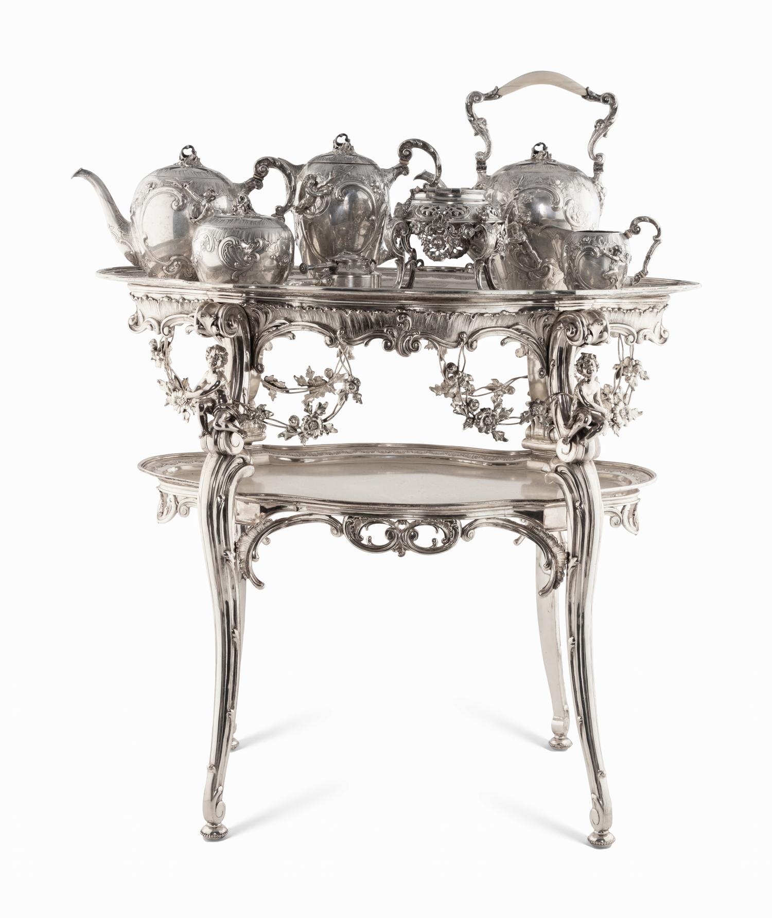 A Rare German Silver Two-Tier Tea Table with Matching Five-Piece Tea Service and Two Trays