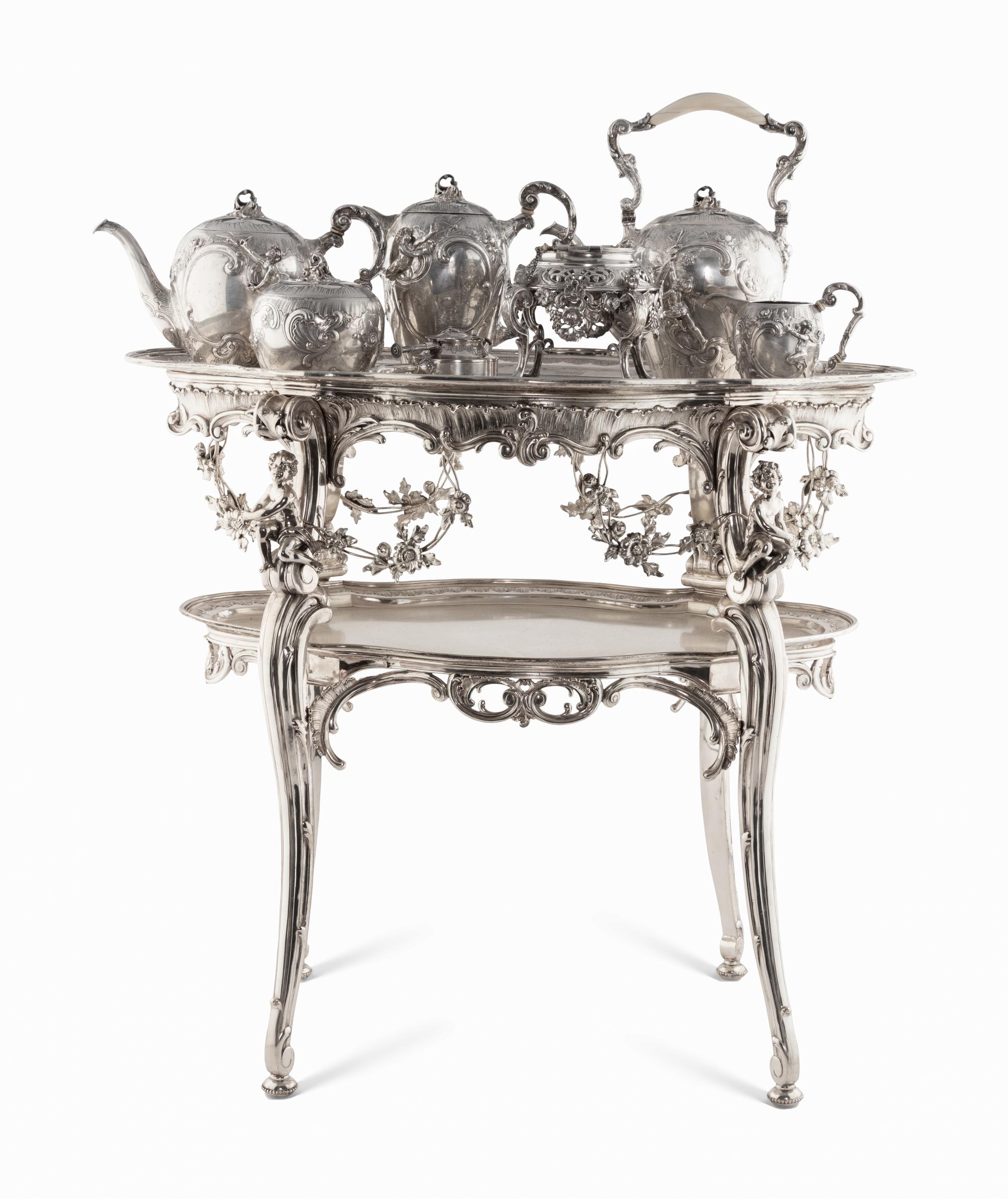 A Rare German Silver Two-Tier Tea Table with Matching Five-Piece Tea Service and Two Trays