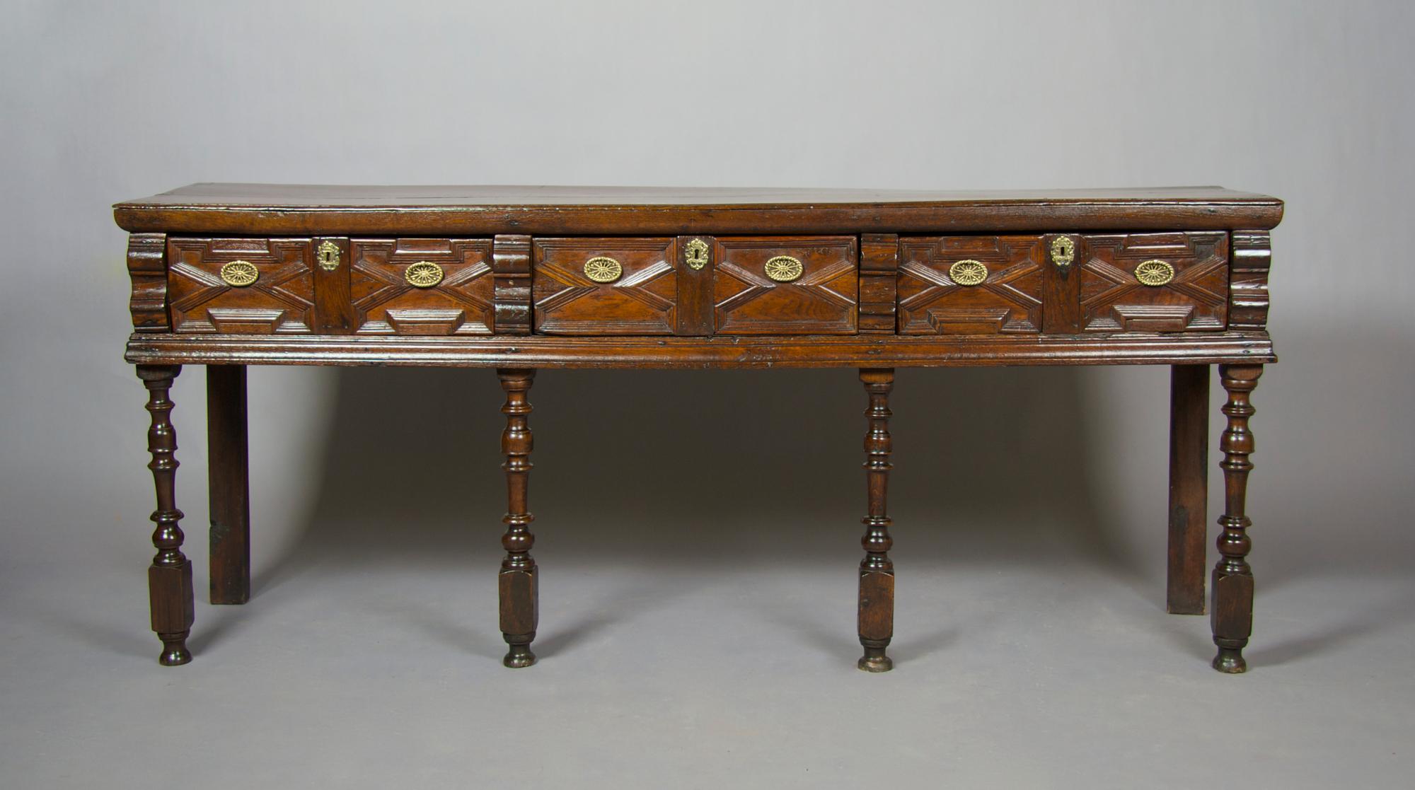 An English Charles II Style Sideboard, Height 34 1/2 x width 83 x depth 19 1/2 inches.