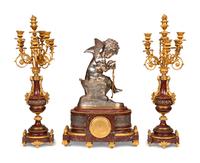 A French Gilt and Silvered Bronze and Rouge Marble Three-Piece Clock Garniture