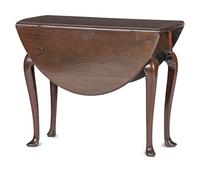 A Queen Anne Carved and Figured Mahogany Drop-Leaf Slipper Foot Table