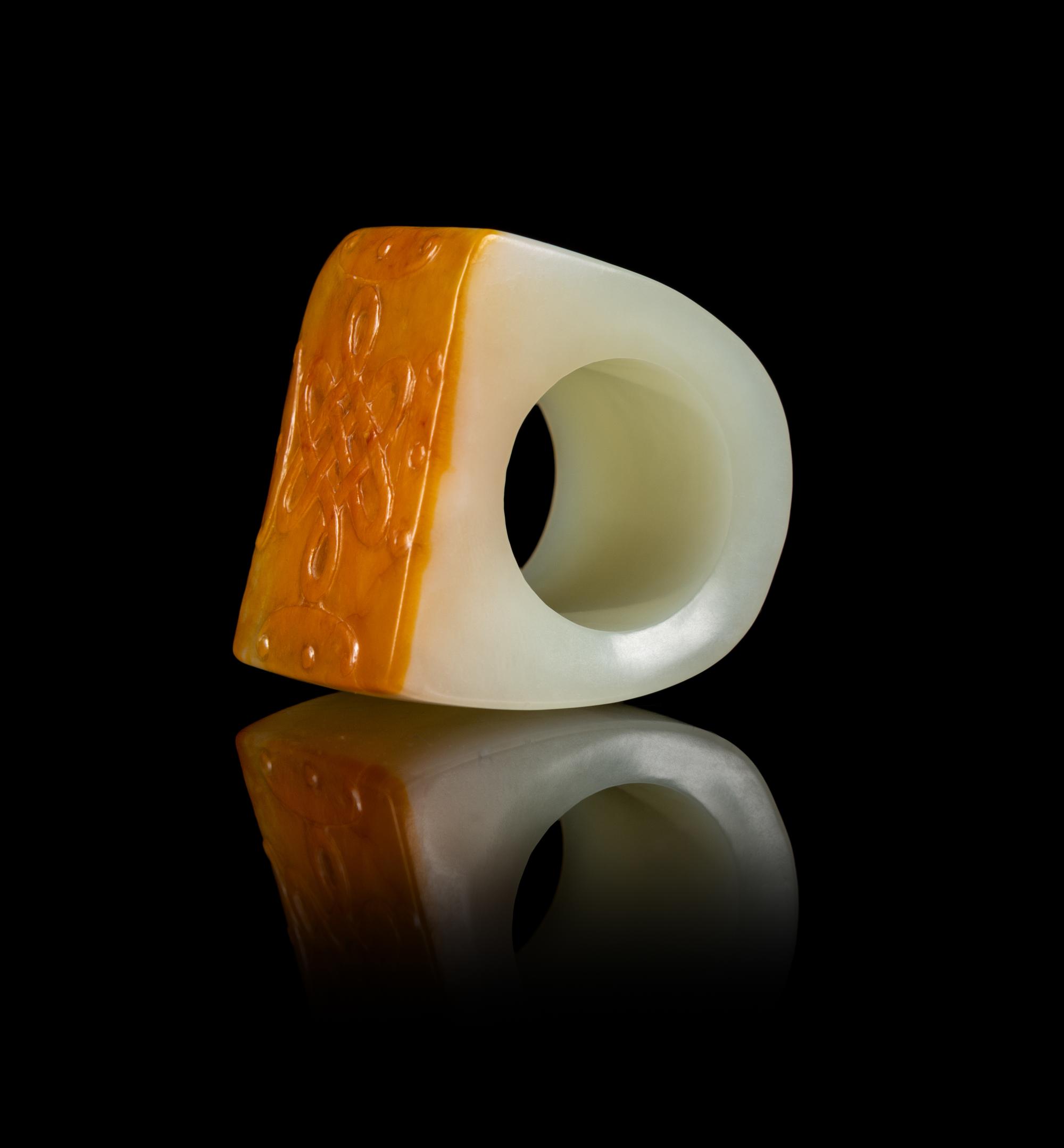 A Chinese Russet and White Jade Archer’s Ring