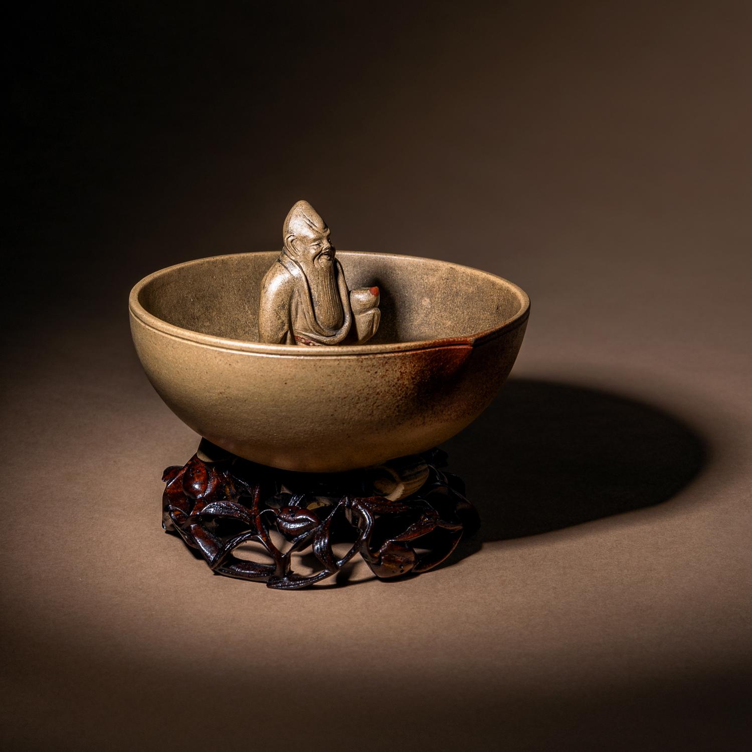 A Rare Yixing Peach-Form 'Figure' Puzzle Cup with Impressed Seals 'Chen', 'Mingyuan' and Wood Stand 陳鳴遠款醉翁桃形公道杯