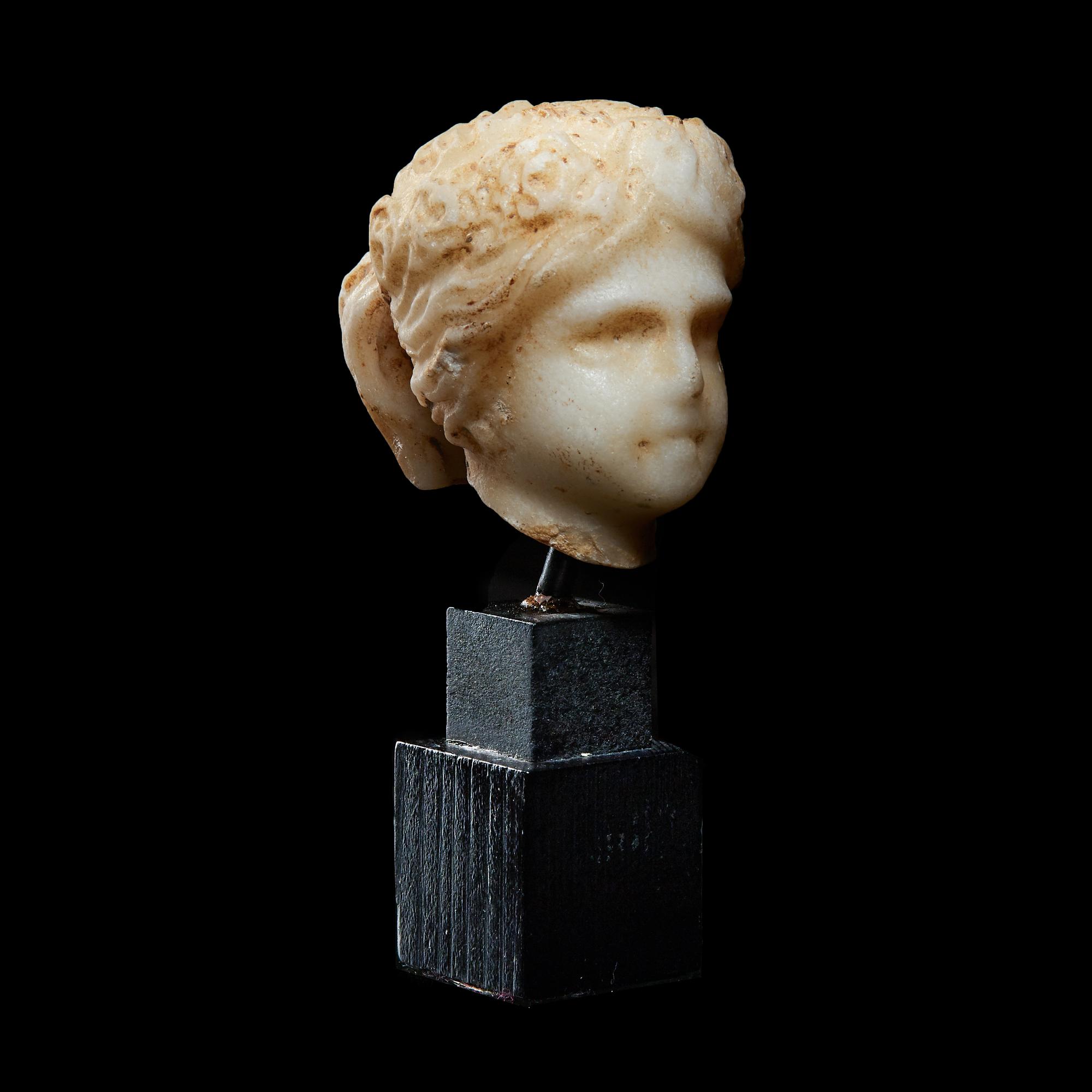A Roman Marble Head of a Muse, Possibly Flora
