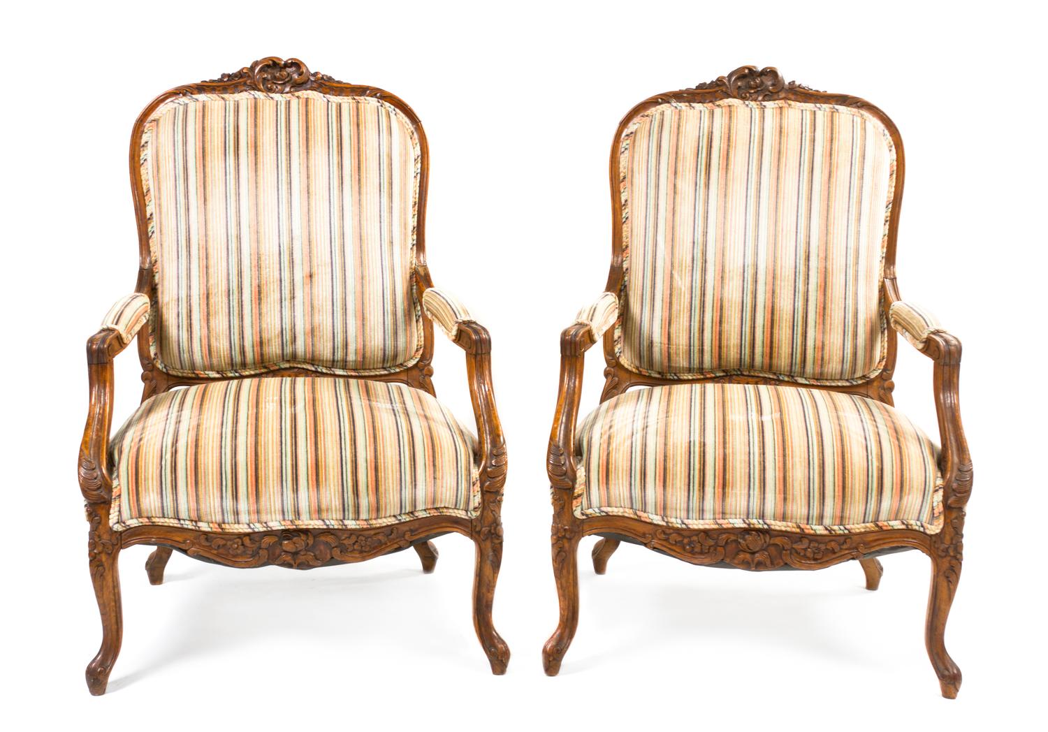 A Pair of Louis XV Style Carved Walnut Fauteuils, Height 42 inches.