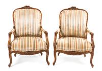 A Pair of Louis XV Style Carved Walnut Fauteuils, Height 42 inches.
