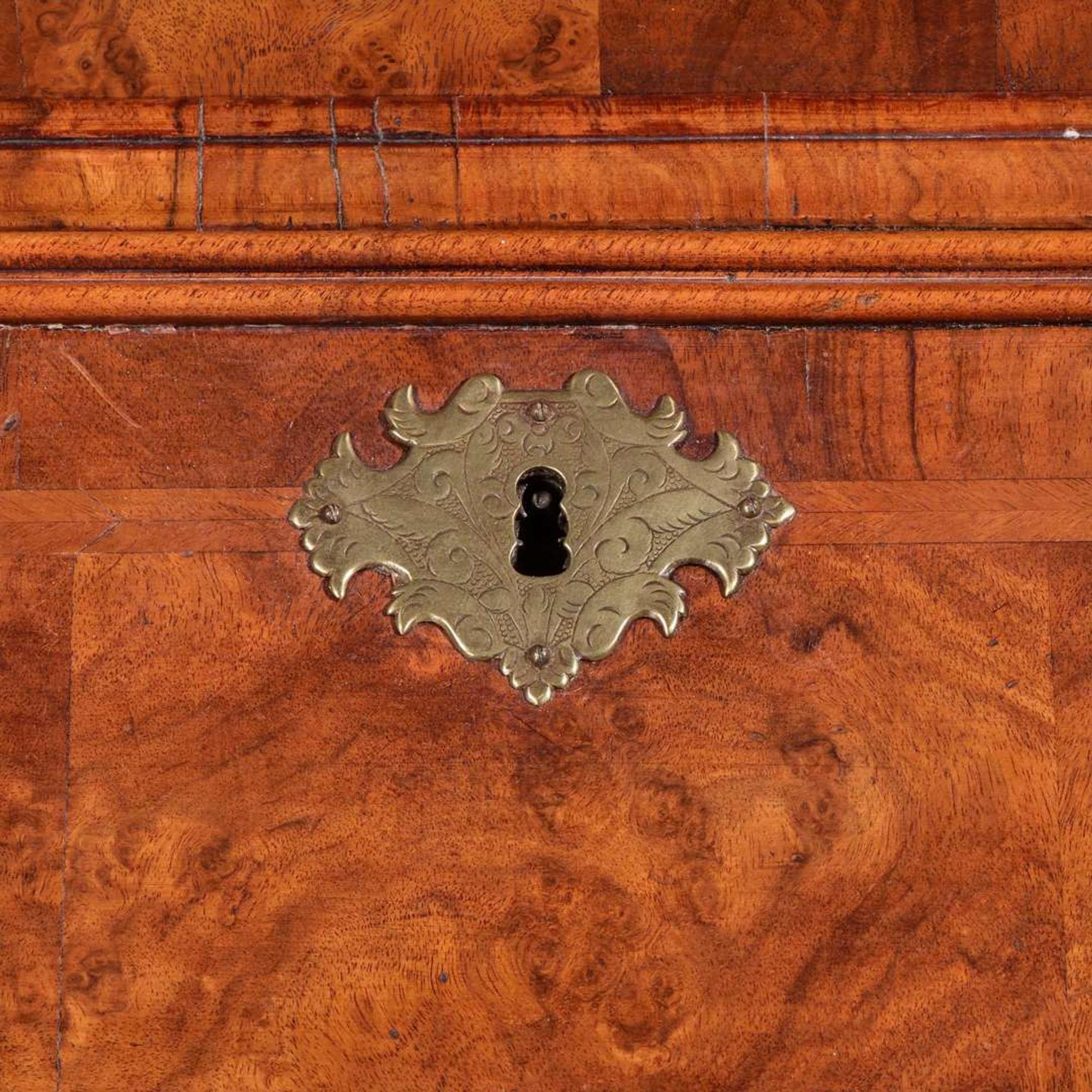 A Queen Anne inlaid and veneered walnut double-dome bureau bookcase circa 1720