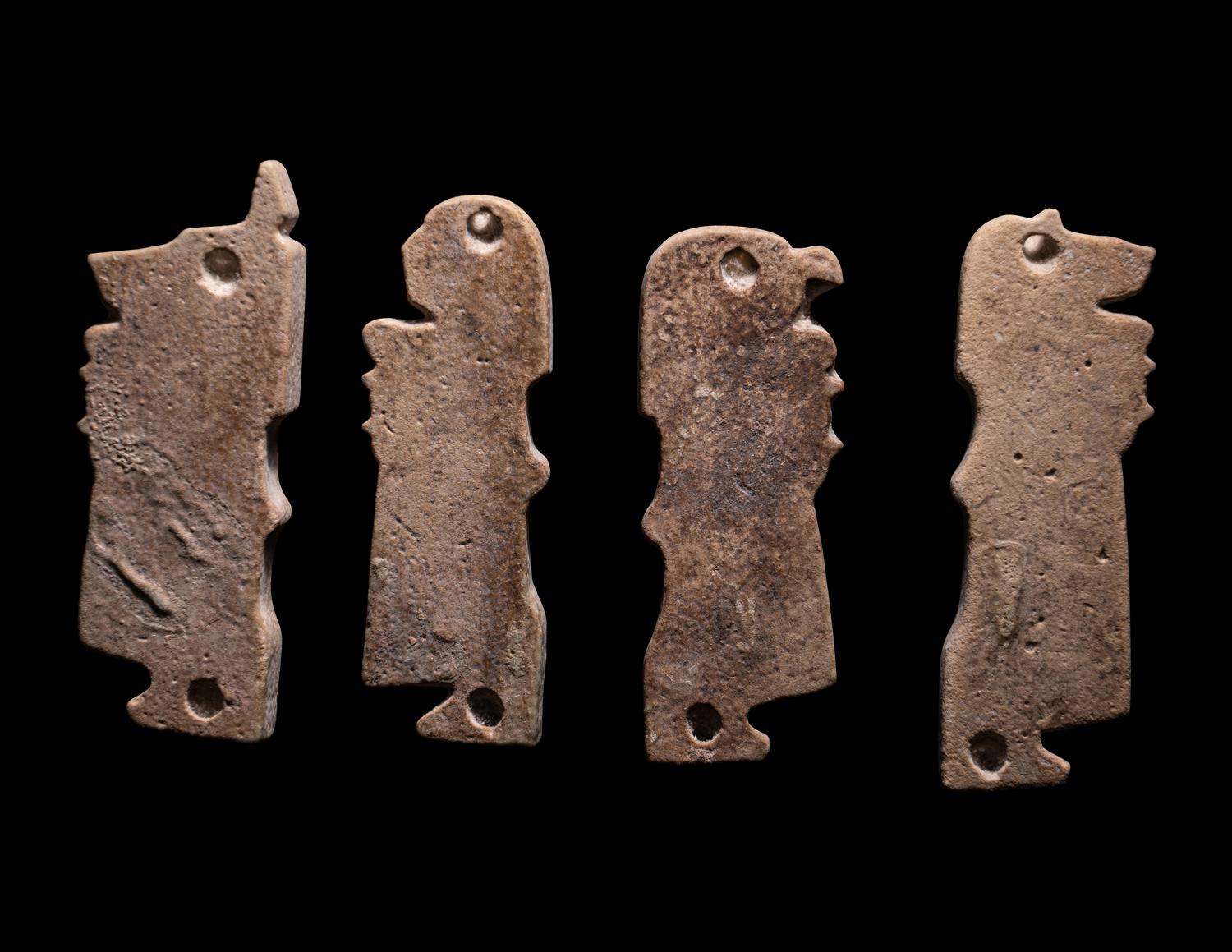 A Set of Four Sons of Horus, Two Scarab Wings, and Two Heads of Horus as a Falcon