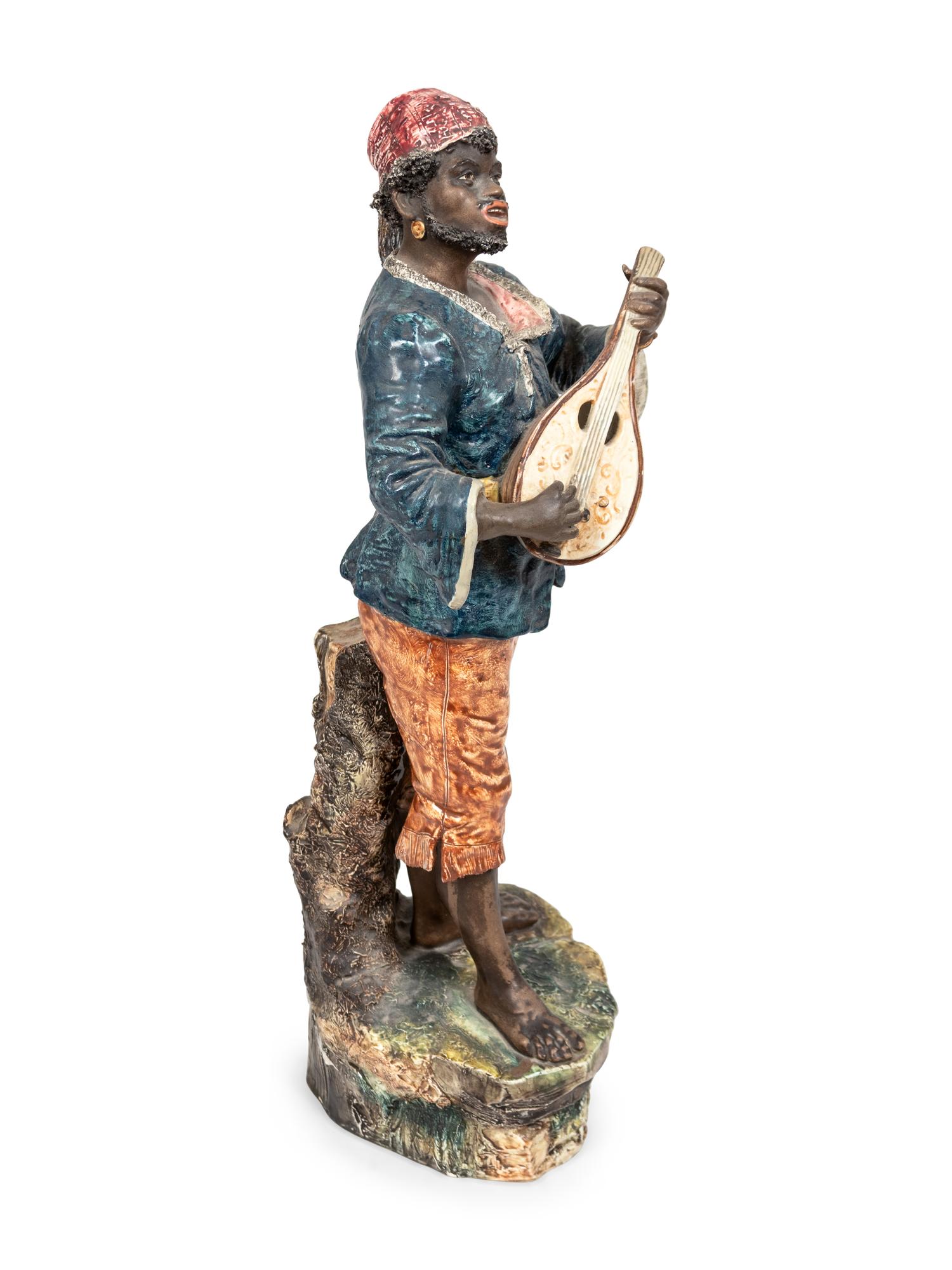 A Glazed Ceramic Figure of a Musician