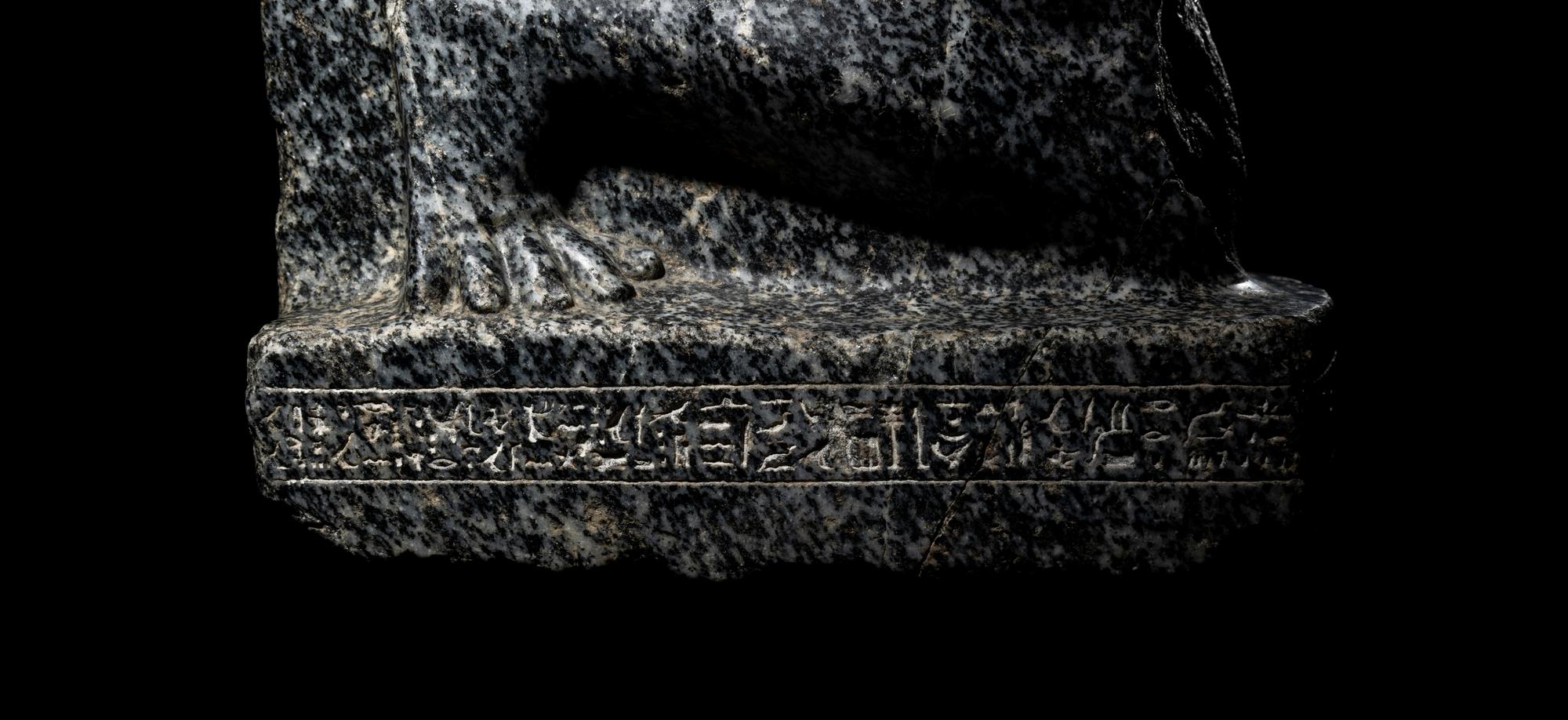An Egyptian Gneiss Fragment of a Kneeling Figure