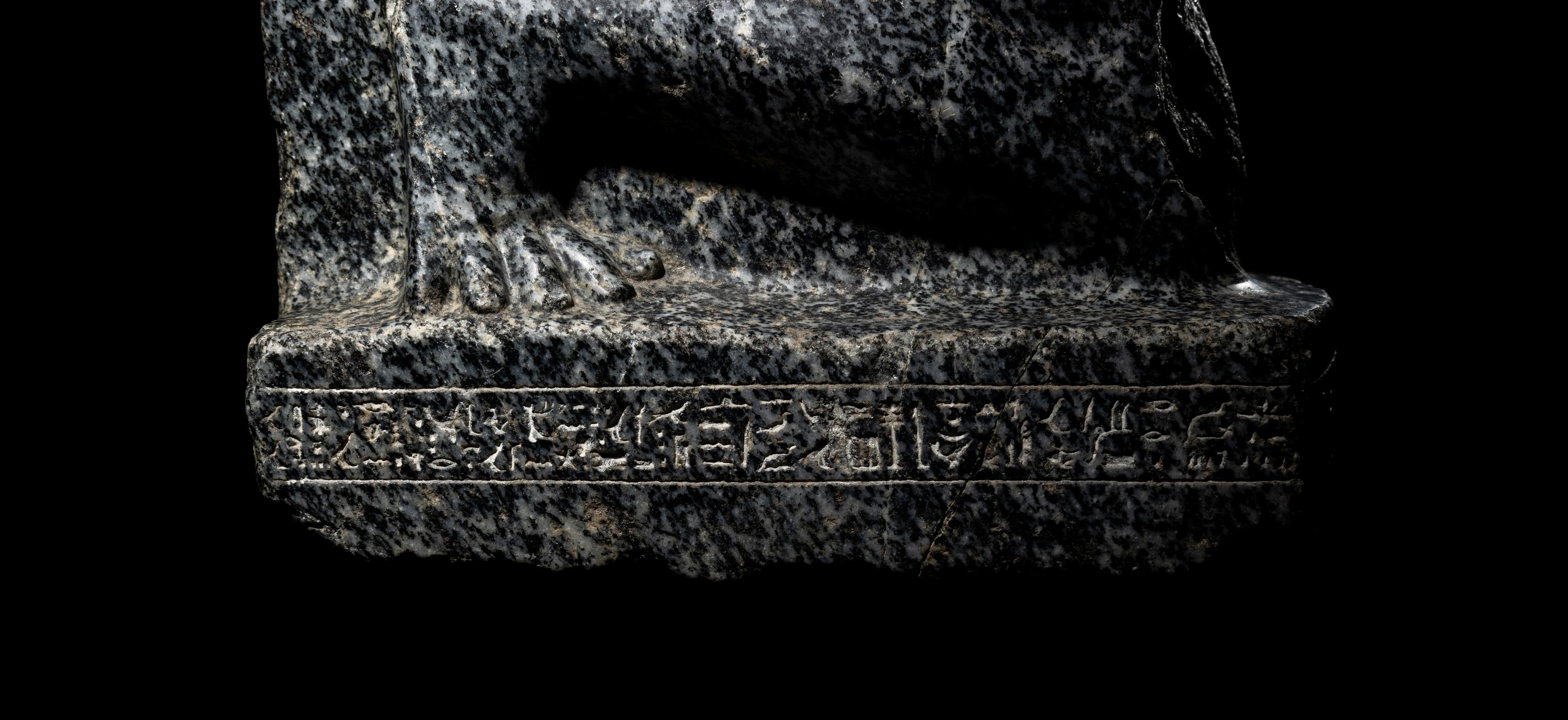 An Egyptian Gneiss Fragment of a Kneeling Figure