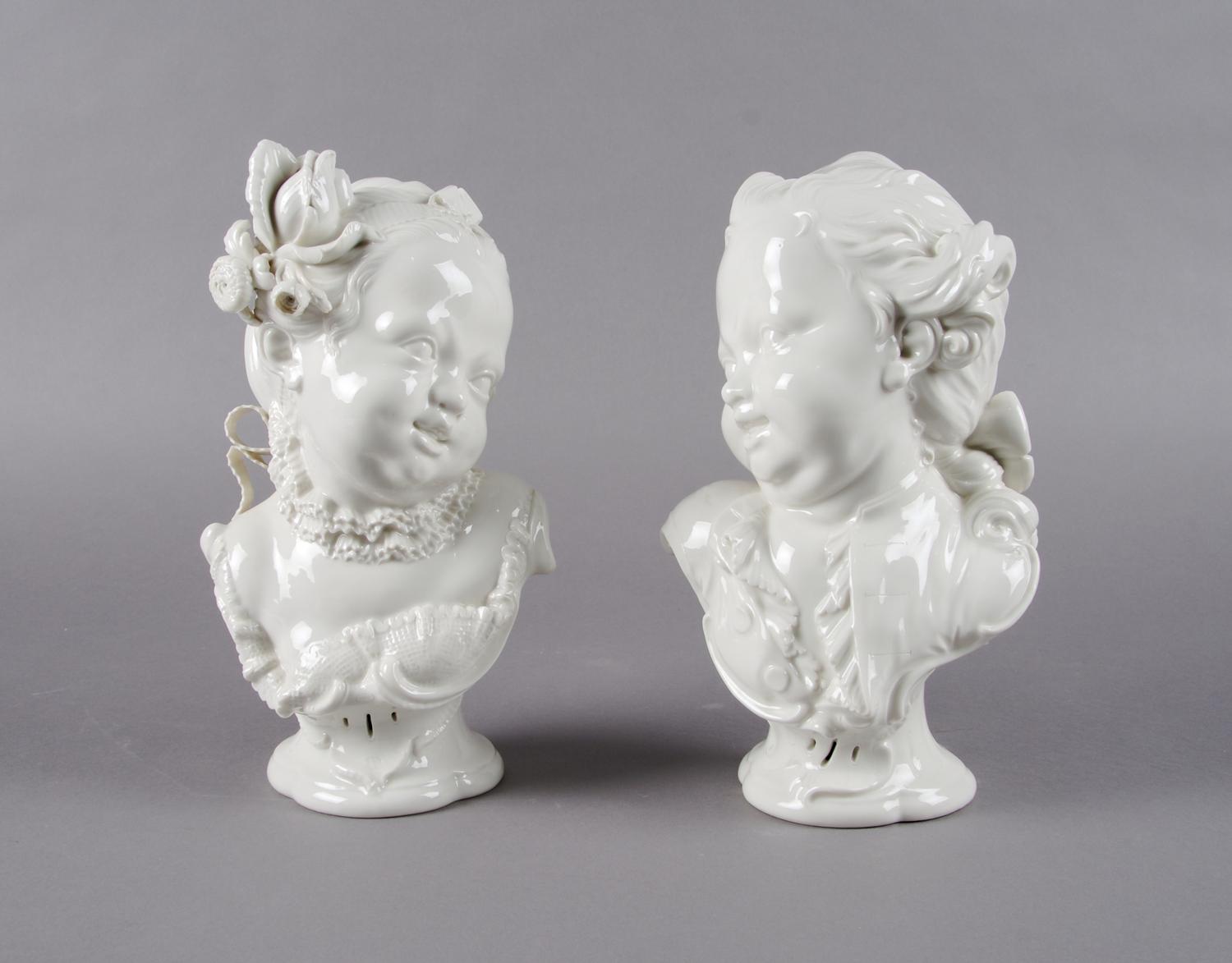 A Pair of Nymphenburg Blanc de Chine Busts of Children, Height 10 1/4 inches.