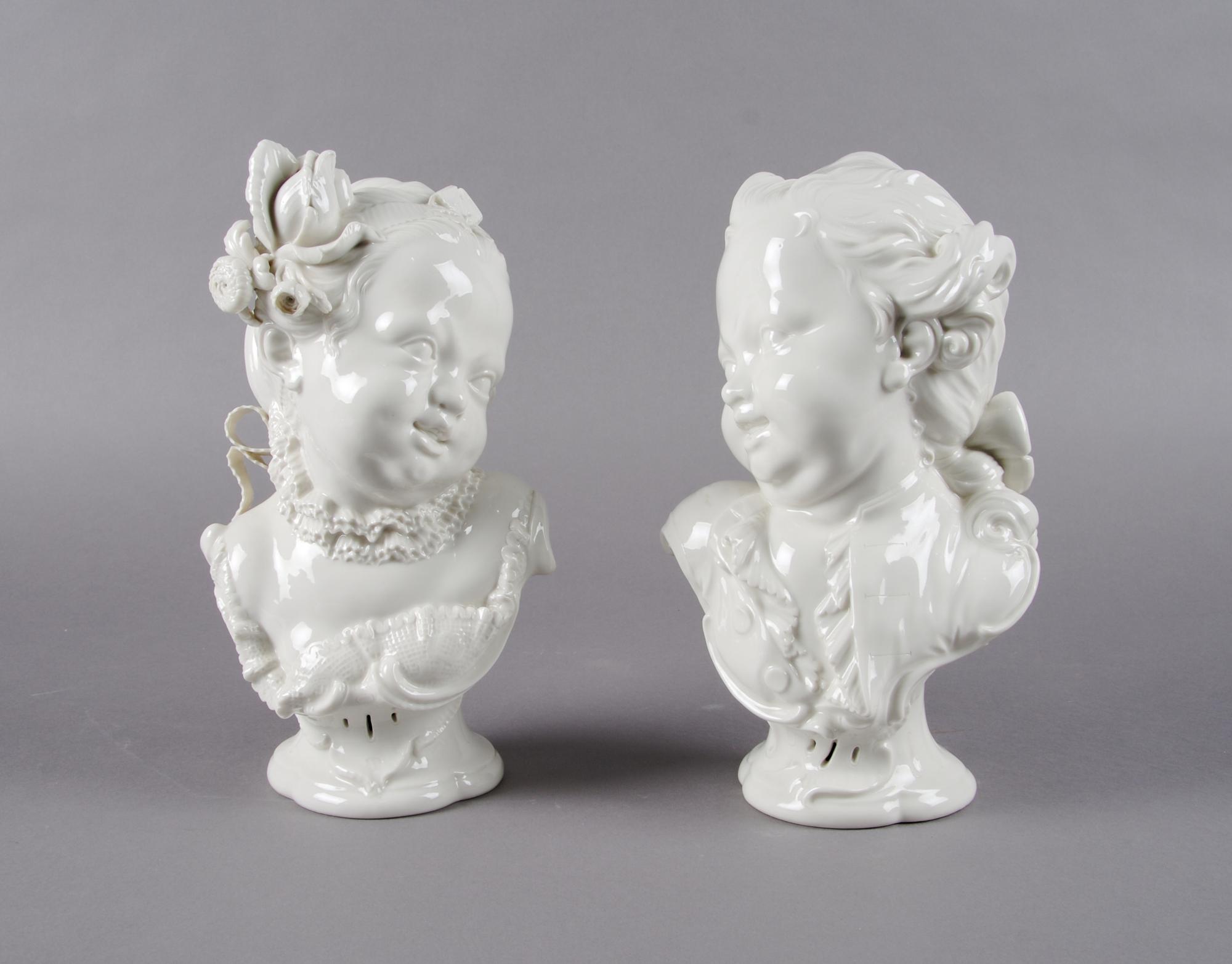 A Pair of Nymphenburg Blanc de Chine Busts of Children, Height 10 1/4 inches.