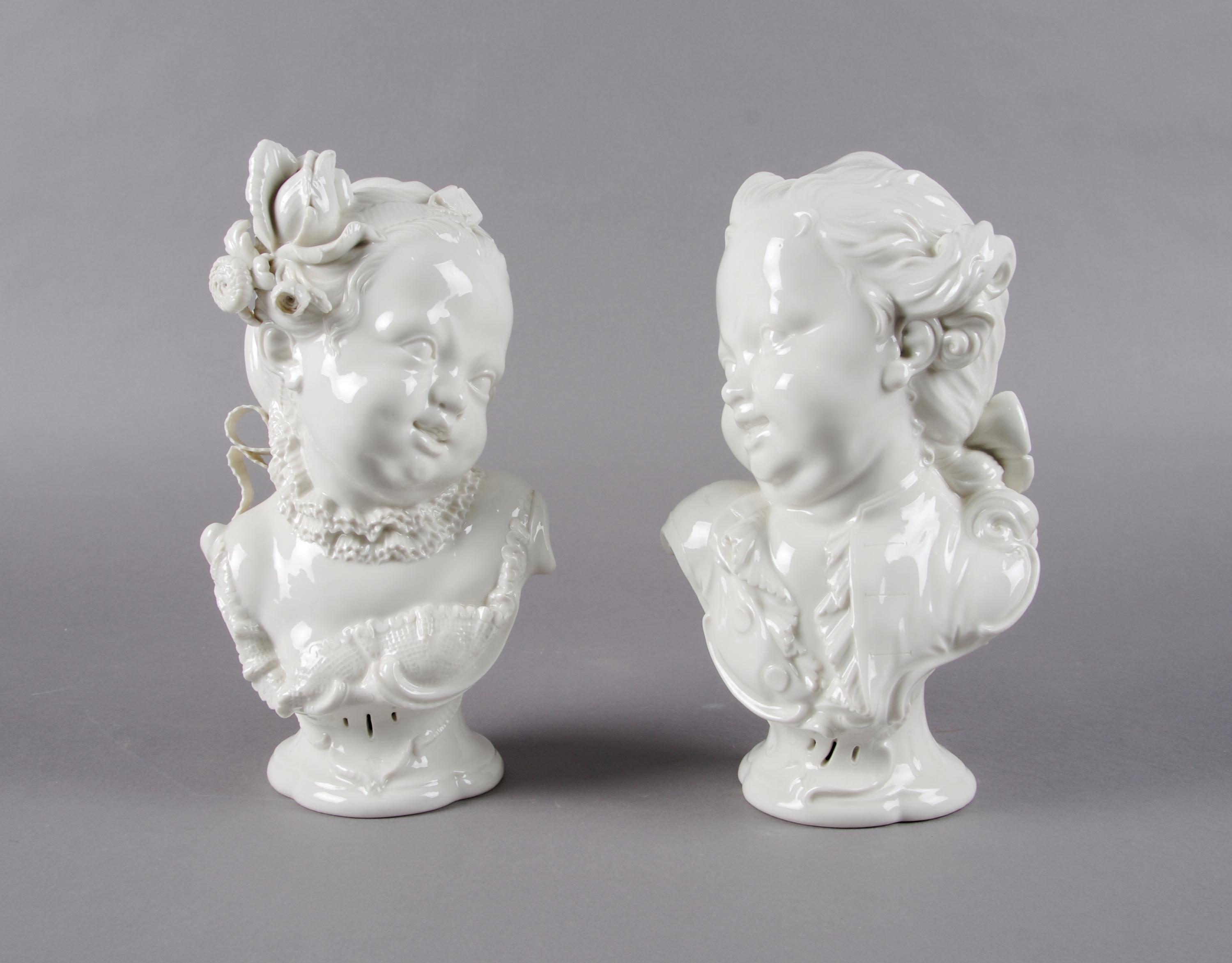 A Pair of Nymphenburg Blanc de Chine Busts of Children, Height 10 1/4 inches.