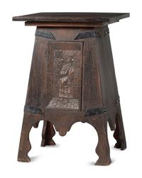 An Arts and Crafts Carved Oak Wine Cellarette