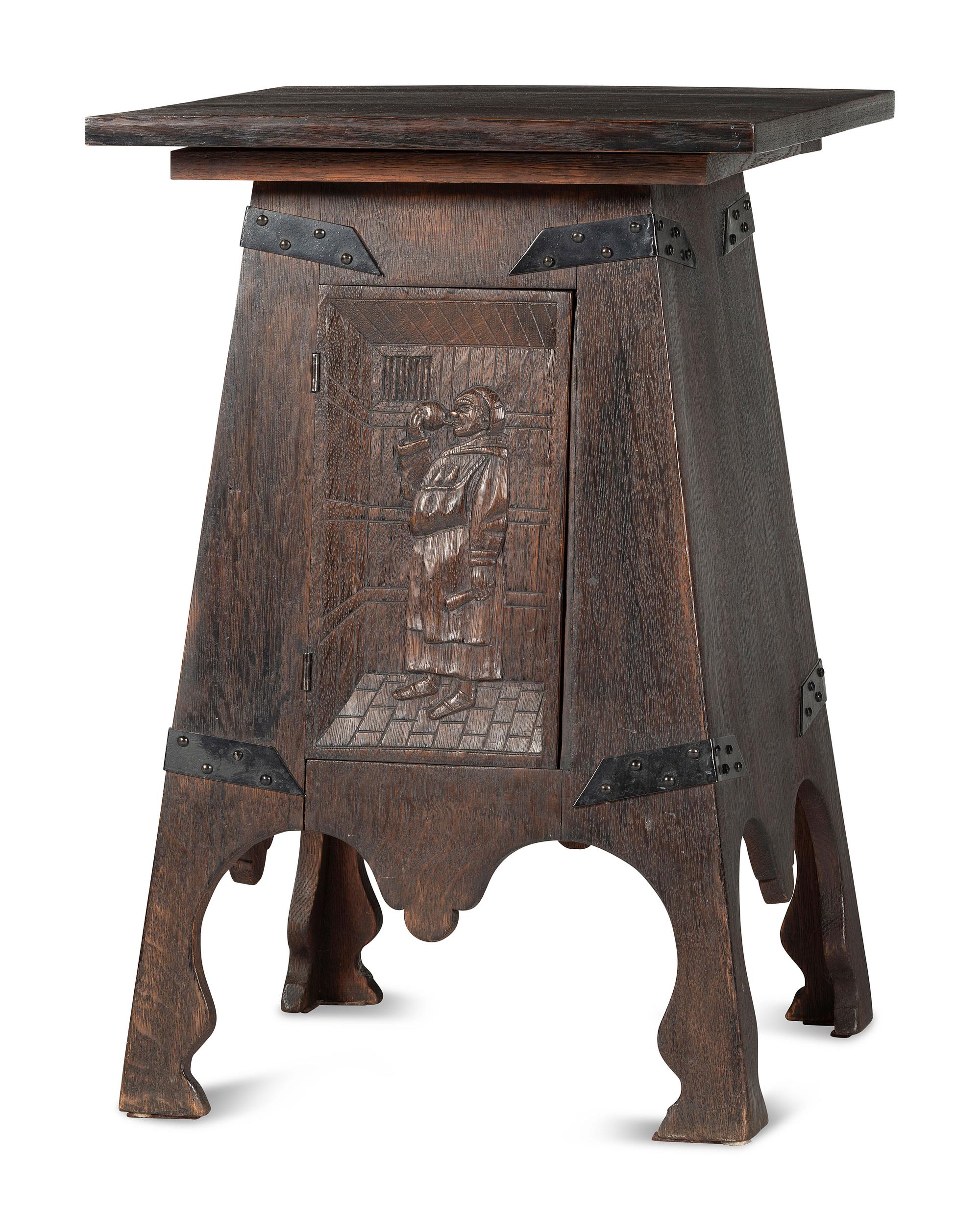 An Arts and Crafts Carved Oak Wine Cellarette