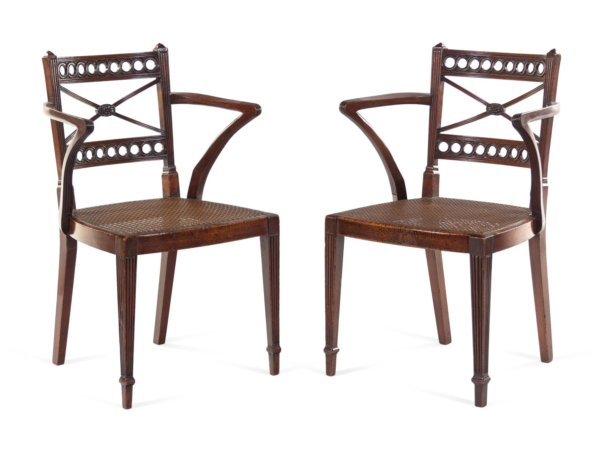 A Pair of Regency Carved Mahogany Cane Upholstered Armchairs