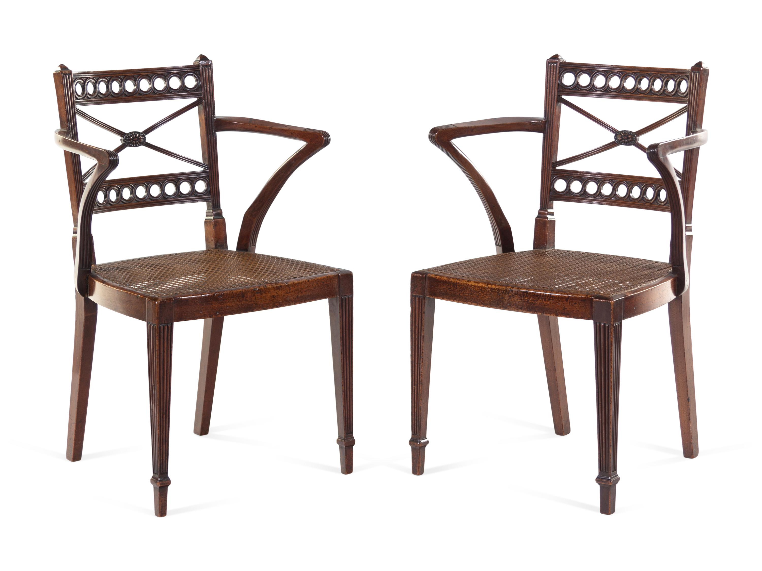 A Pair of Regency Carved Mahogany Cane Upholstered Armchairs