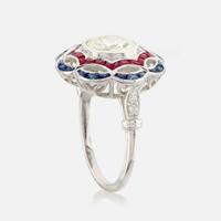 A diamond, ruby, sapphire, and white gold ring
