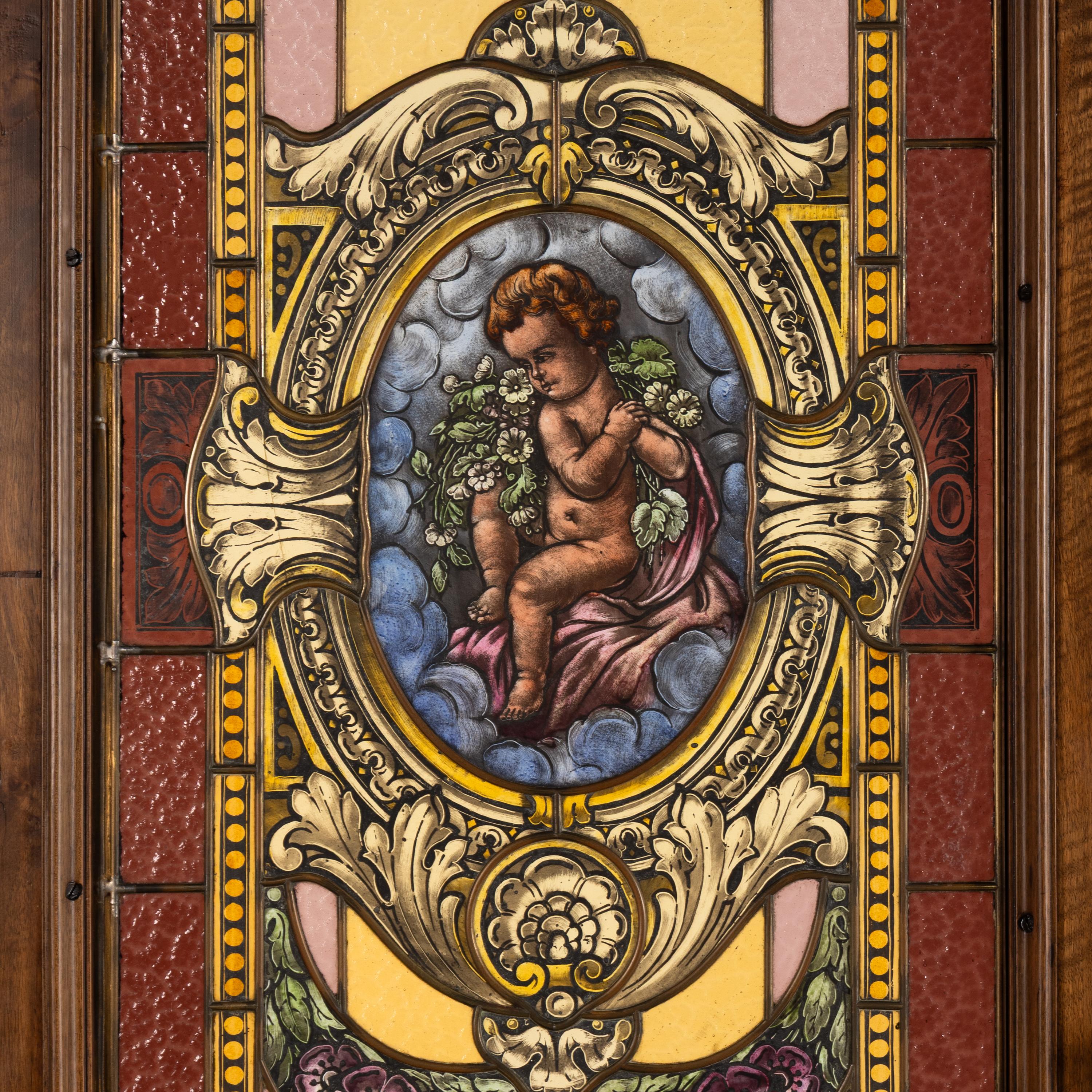A French Carved Walnut and Leaded Glass Double-Door Portal