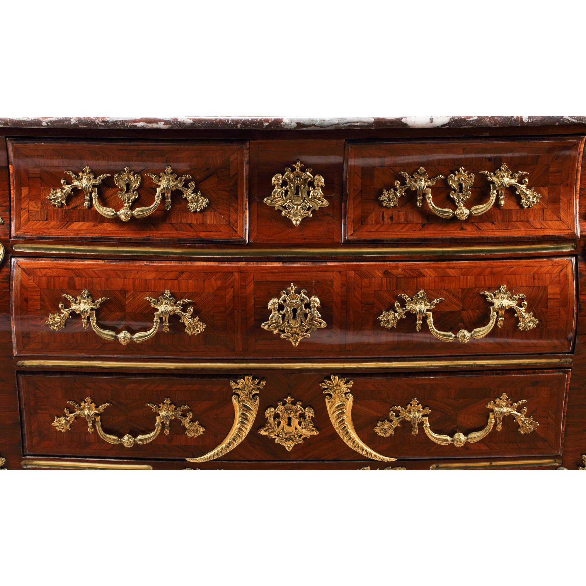 A Régence Gilt Bronze Mounted Marquetry Marble-Top Commode