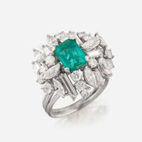 An emerald, diamond, and platinum ring