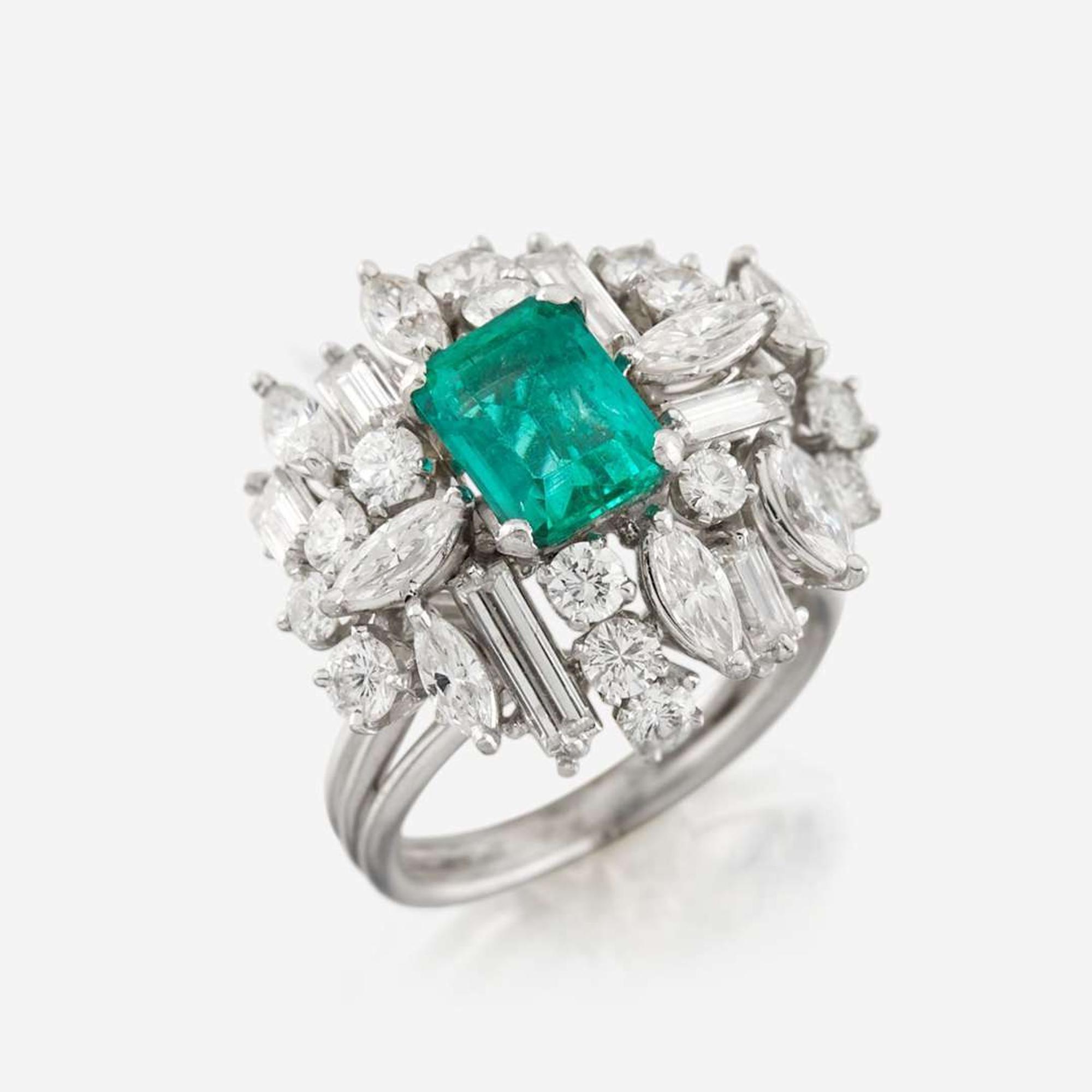 An emerald, diamond, and platinum ring
