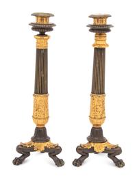 A Pair of French Parcel Gilt and Patinated Bronze Candlesticks