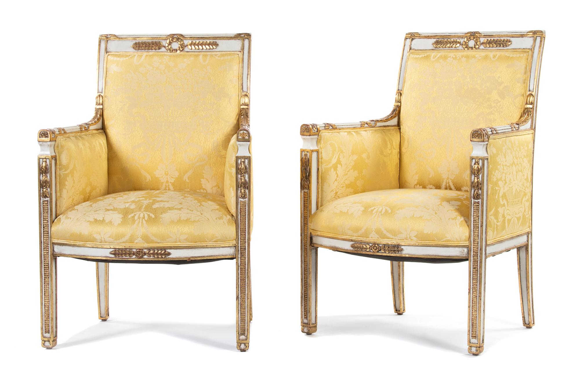 A Pair of Directoire Style Parcel-Gilt and Cream-Painted Armchairs