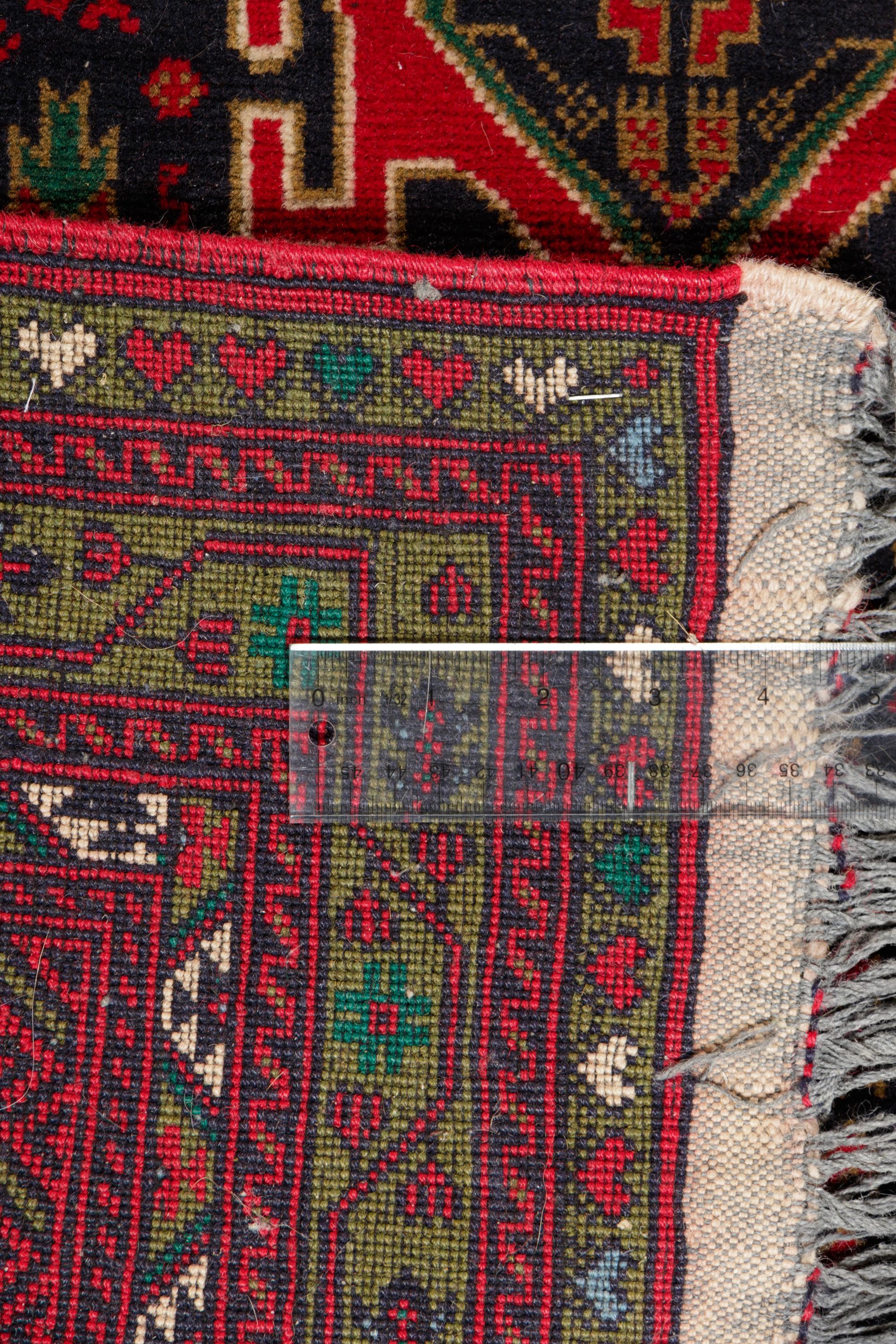 A Persian Bokhara Wool Rug