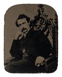 [BOOTH, John Wilkes (1838-1865)]. Tintype depicting a seated John Wilkes Booth, ca 1864.