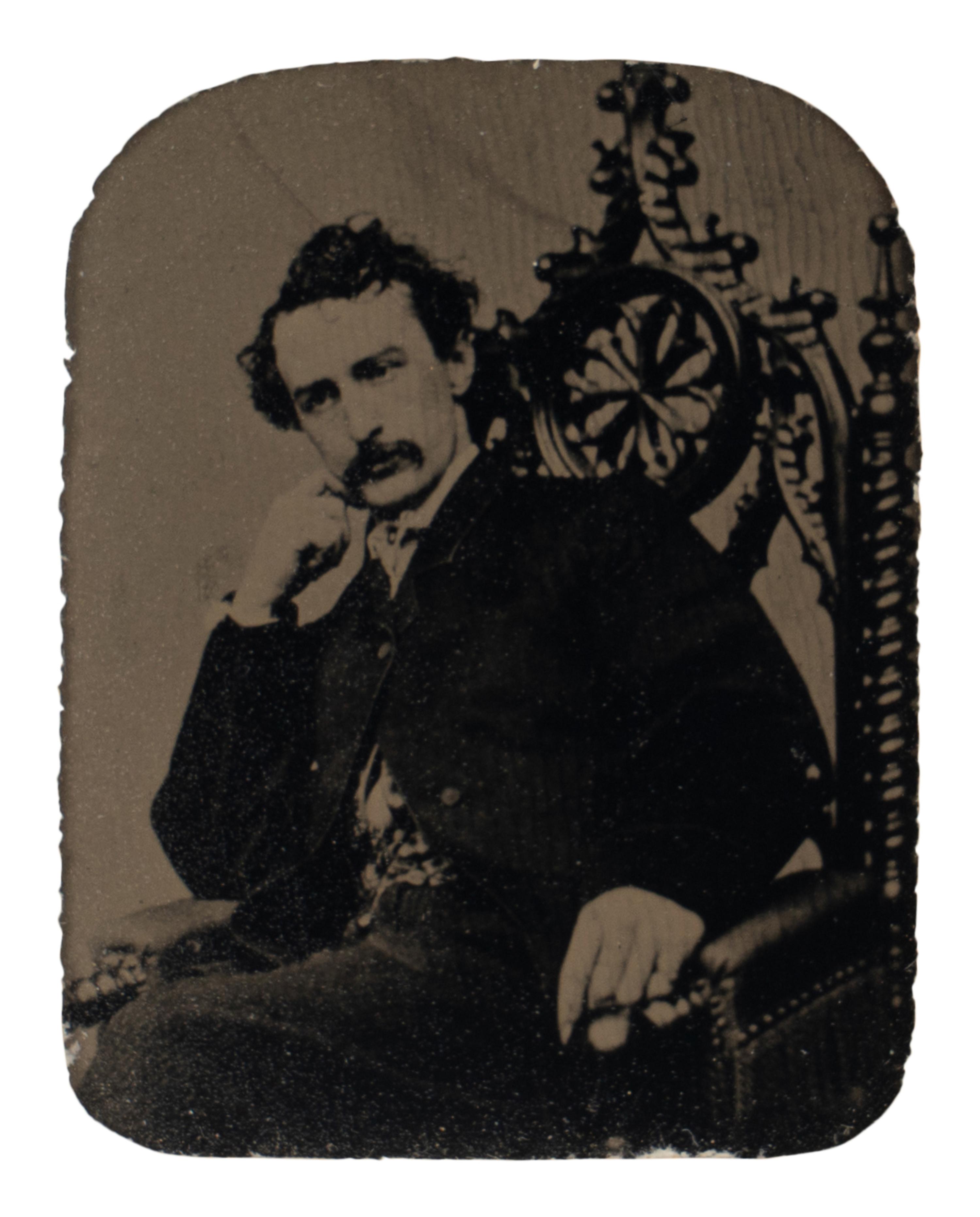 [BOOTH, John Wilkes (1838-1865)]. Tintype depicting a seated John Wilkes Booth, ca 1864.
