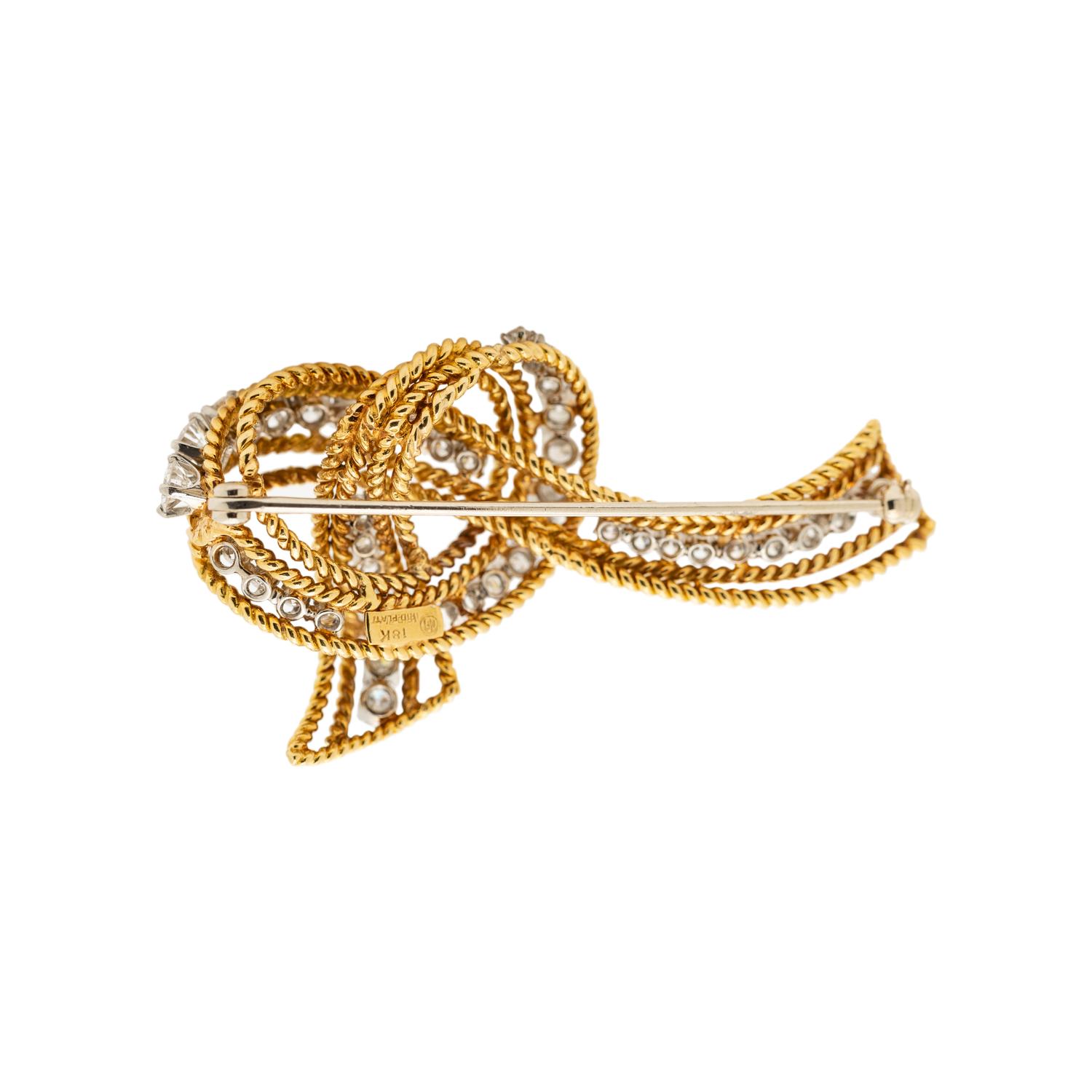 McTEIGUE & CO., YELLOW GOLD, PLATINUM AND DIAMOND RIBBON BROOCH