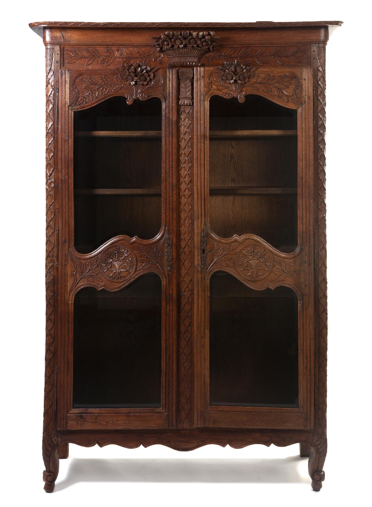 A French Provincial Oak Vitrine, Height 82 x width 50 x depth 19 inches.