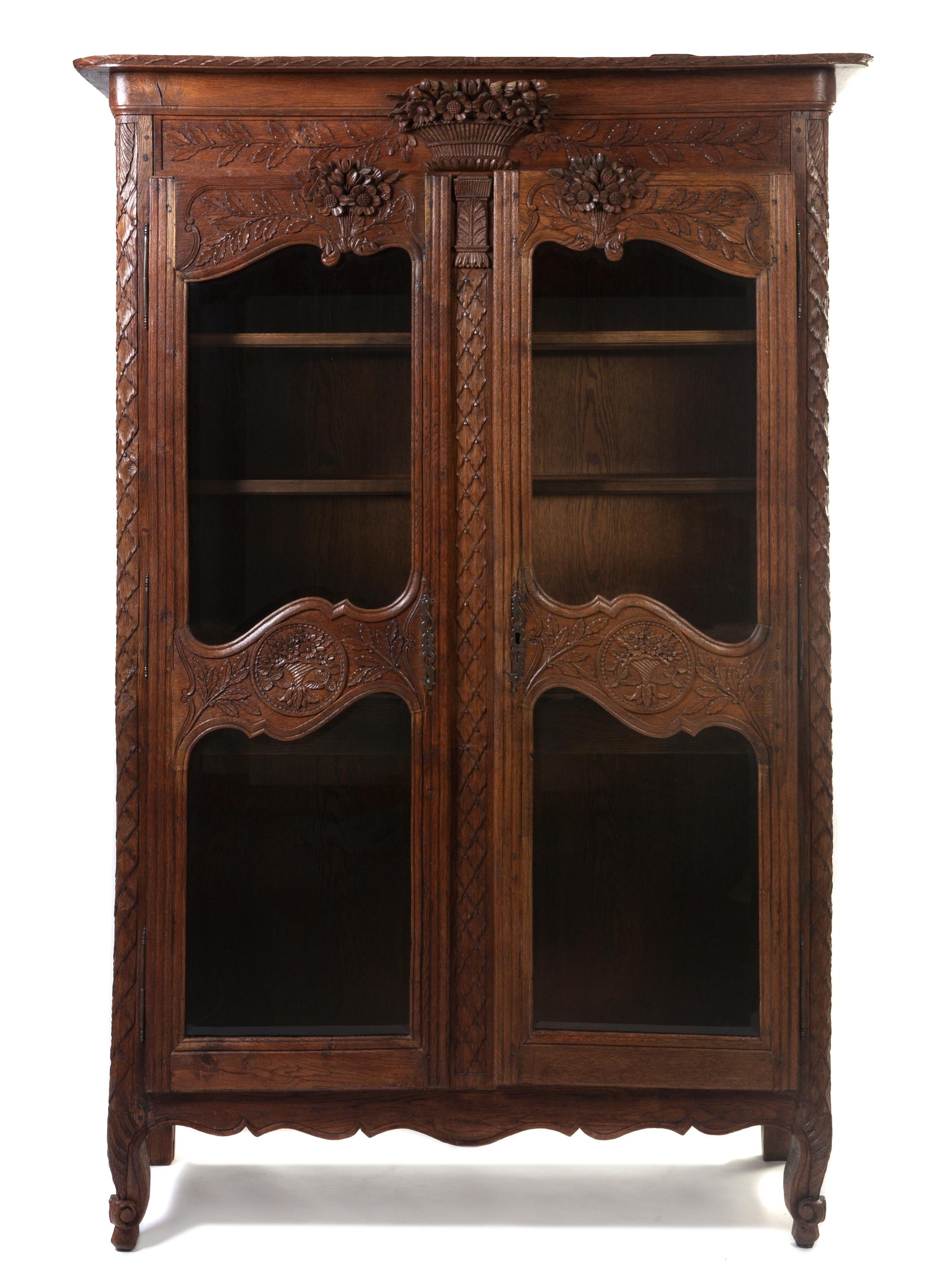 A French Provincial Oak Vitrine, Height 82 x width 50 x depth 19 inches.