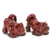 A Pair of Sang de Boeuf Glazed Earthenware Models of Guardian Lions