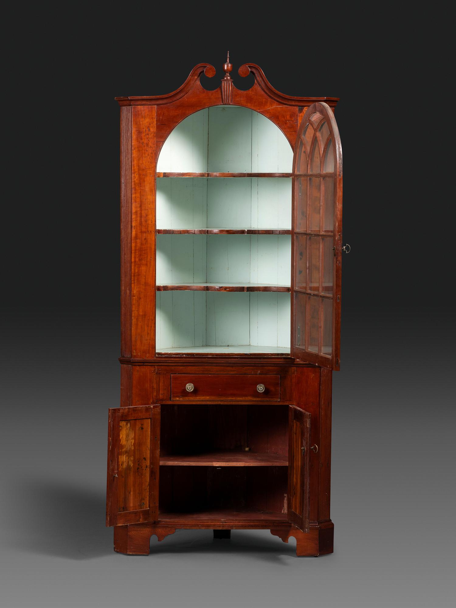 A Late Chippendale Carved Cherrywood Corner Cupboard