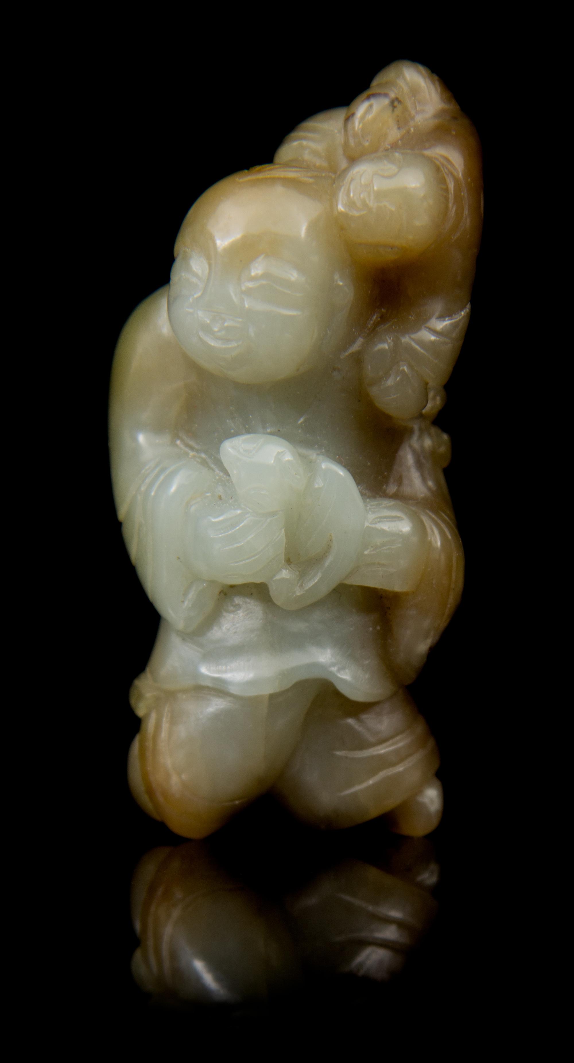 A Carved Jade Toggle Length 2 3/4 inches.