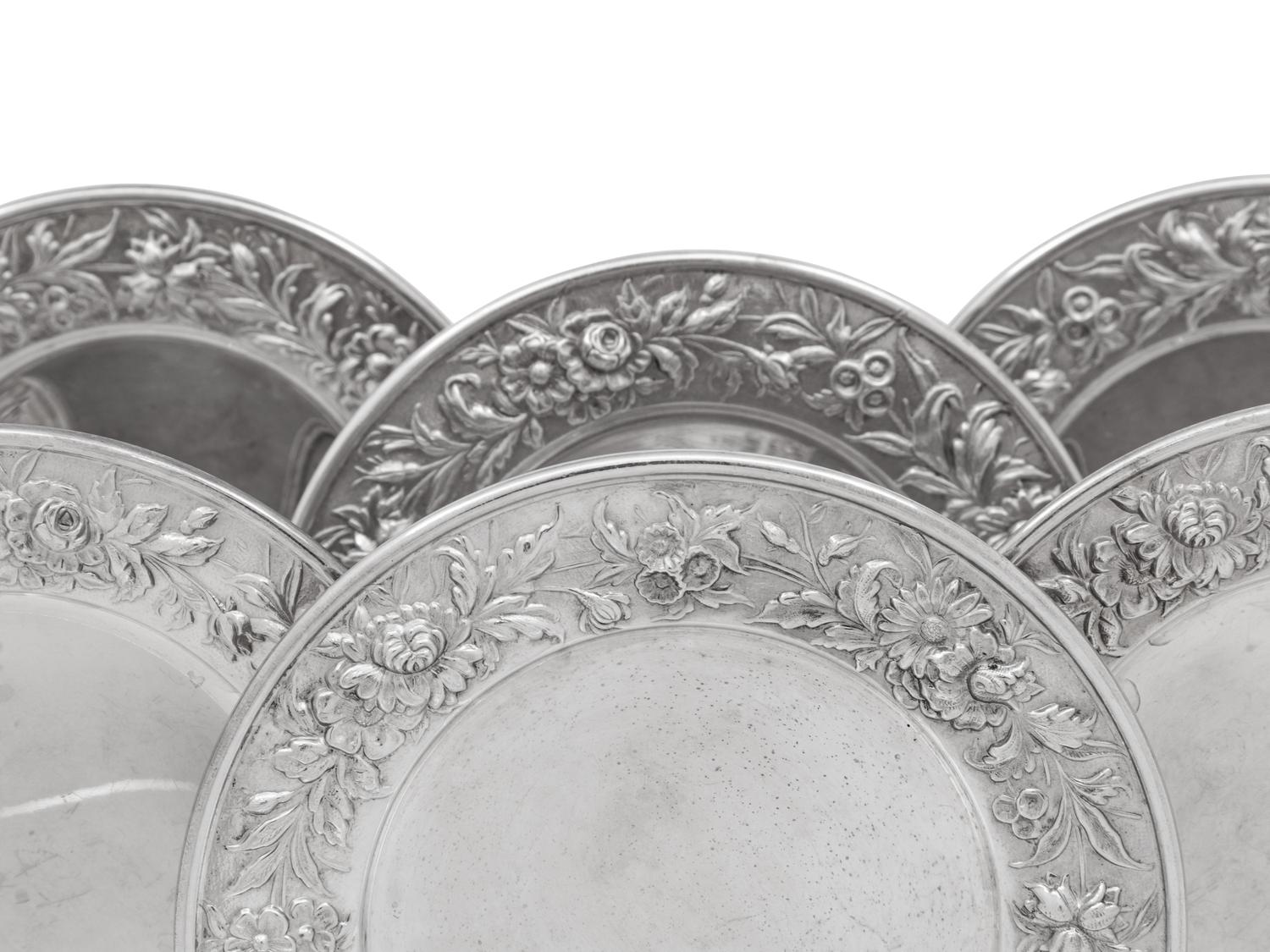A Set of Eight S. Kirk and Son Repousse Silver Bread Plates
