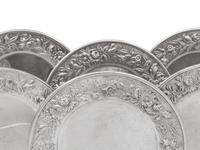 A Set of Eight S. Kirk and Son Repousse Silver Bread Plates