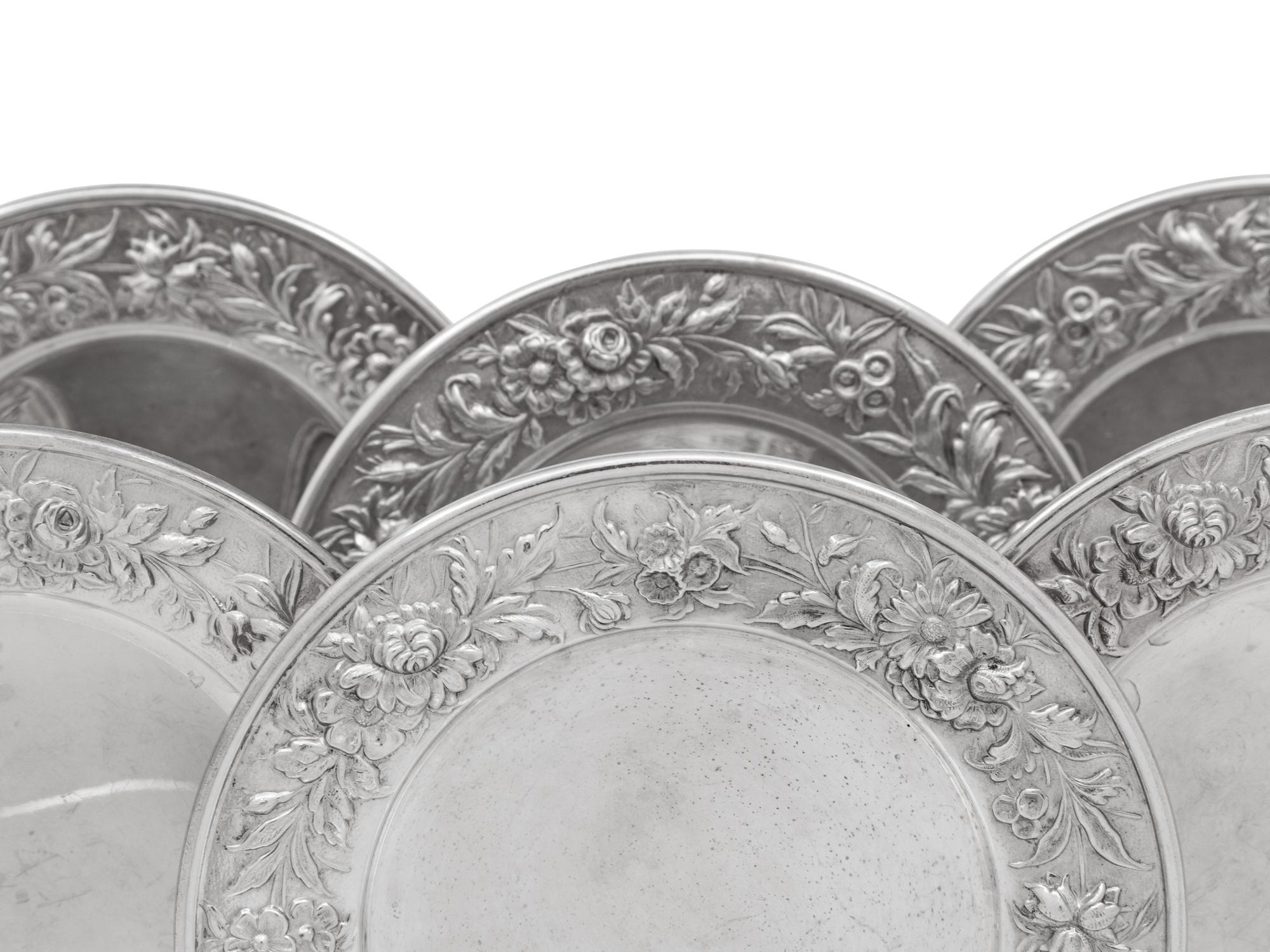 A Set of Eight S. Kirk and Son Repousse Silver Bread Plates